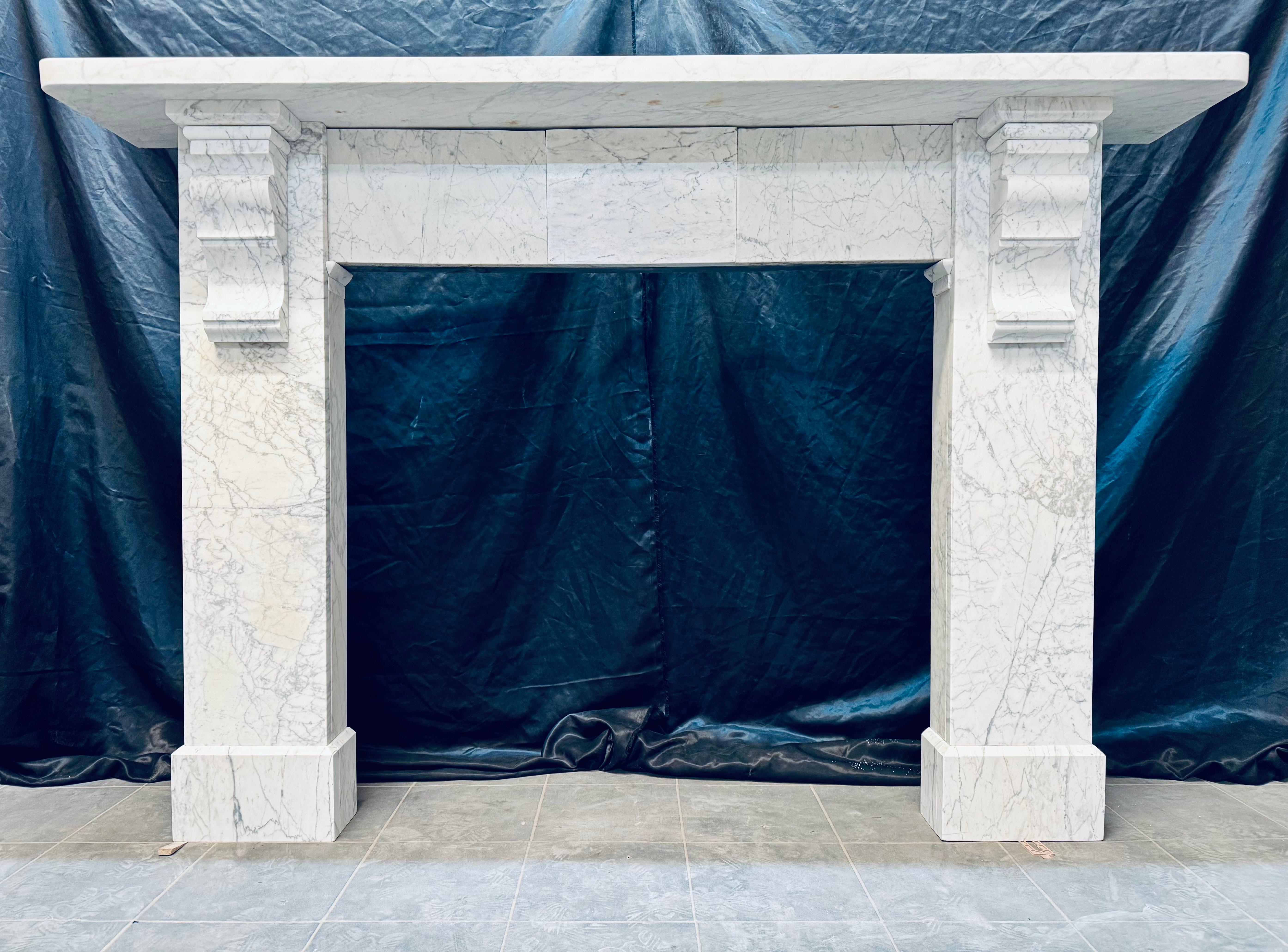 An original Victorian 19th Century Scottish Pencil Veined Carrara marble corbeled   fireplace surround. 
A generous square edged top shelf sits directly above an unadorned tablet frieze, flanked by a sturdy set of jambs hosting two large geometric