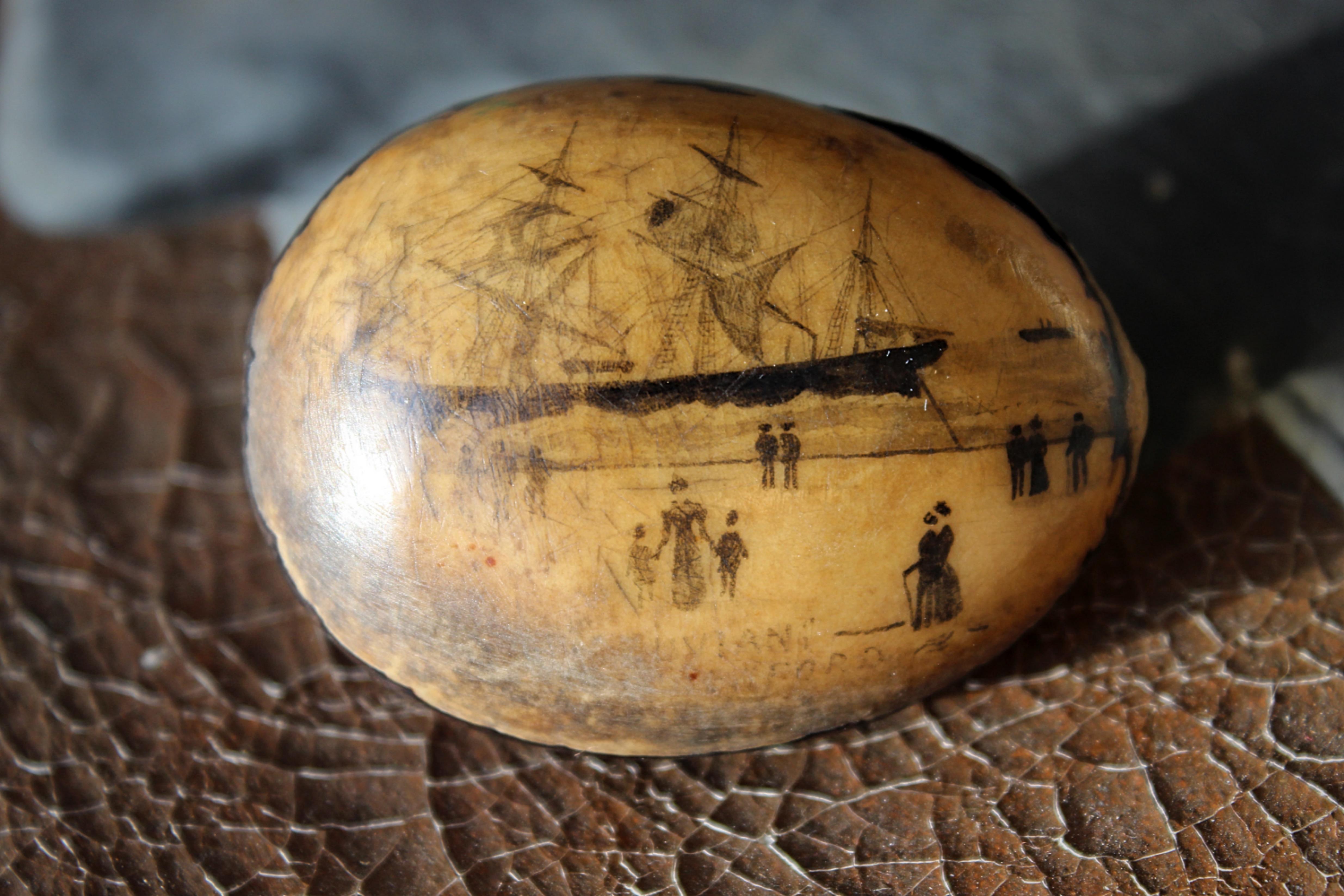 A wonderful early 19th century sailors scrimshaw nut/seed. 

Typically naive and charming, depicting a three masted ship that appears to of run aground.

The name Dylan Ford is just legible on the bottom rim

5.5/4/3cm 