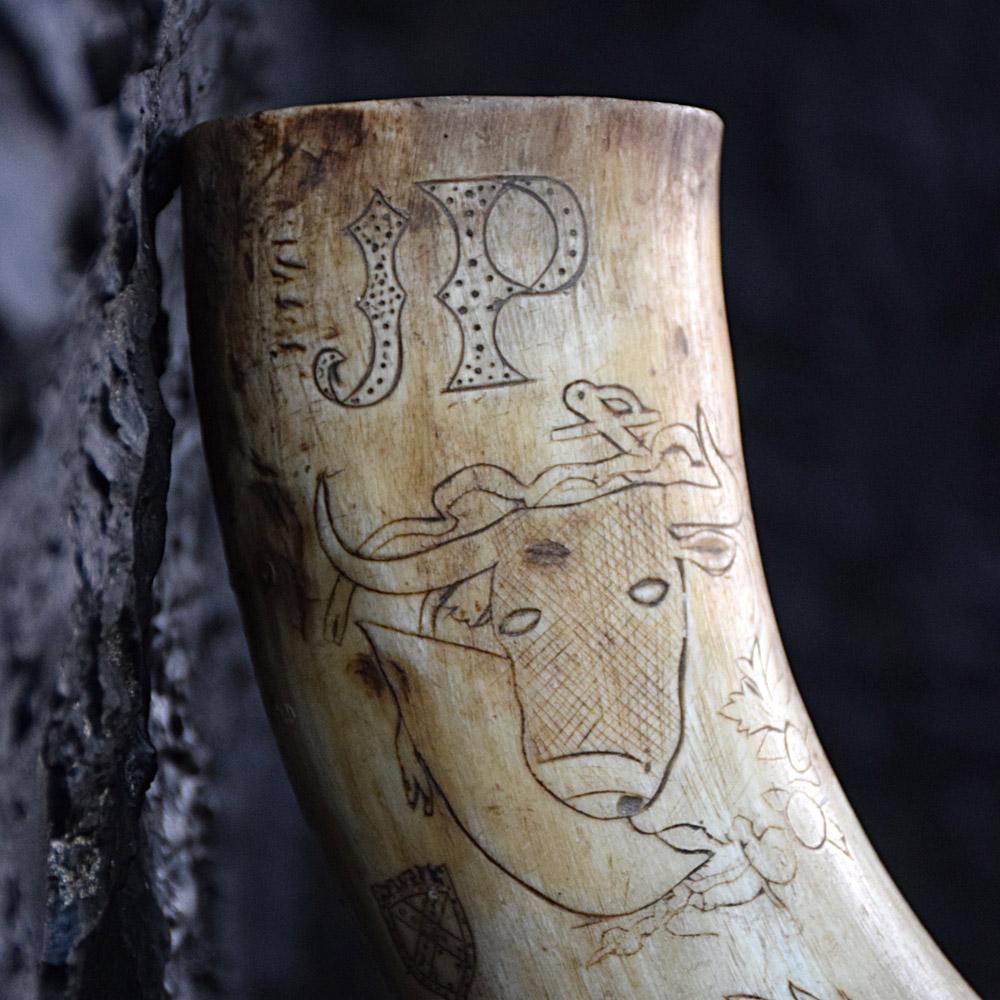 19th century Scrimshaw Spanish powder horn
We are proud to offer an early 19th century Spanish scrimshaw gun powder horn made from bull horn. Covered in some lovely naïve folk-art motifs including heraldic shields, crests, Bulls head, love token