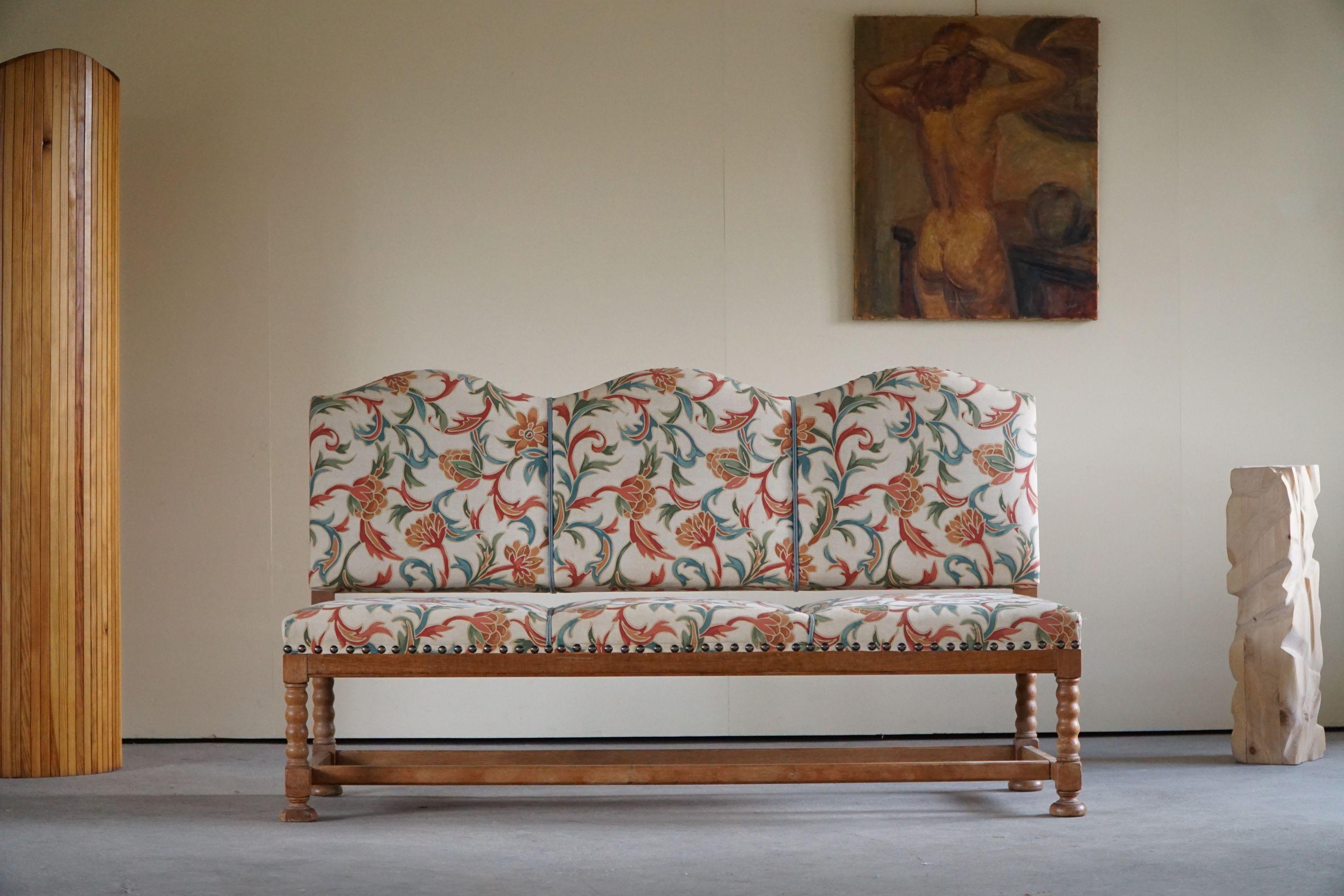 A lovely romantic three seater sofa in a fantastic fabric. Made in solid oak. Hand carved by a Danish cabinetmaker in the 19th century. The overall impression is really good, with only a few signs of wear. 

This stunning sofa will complement many