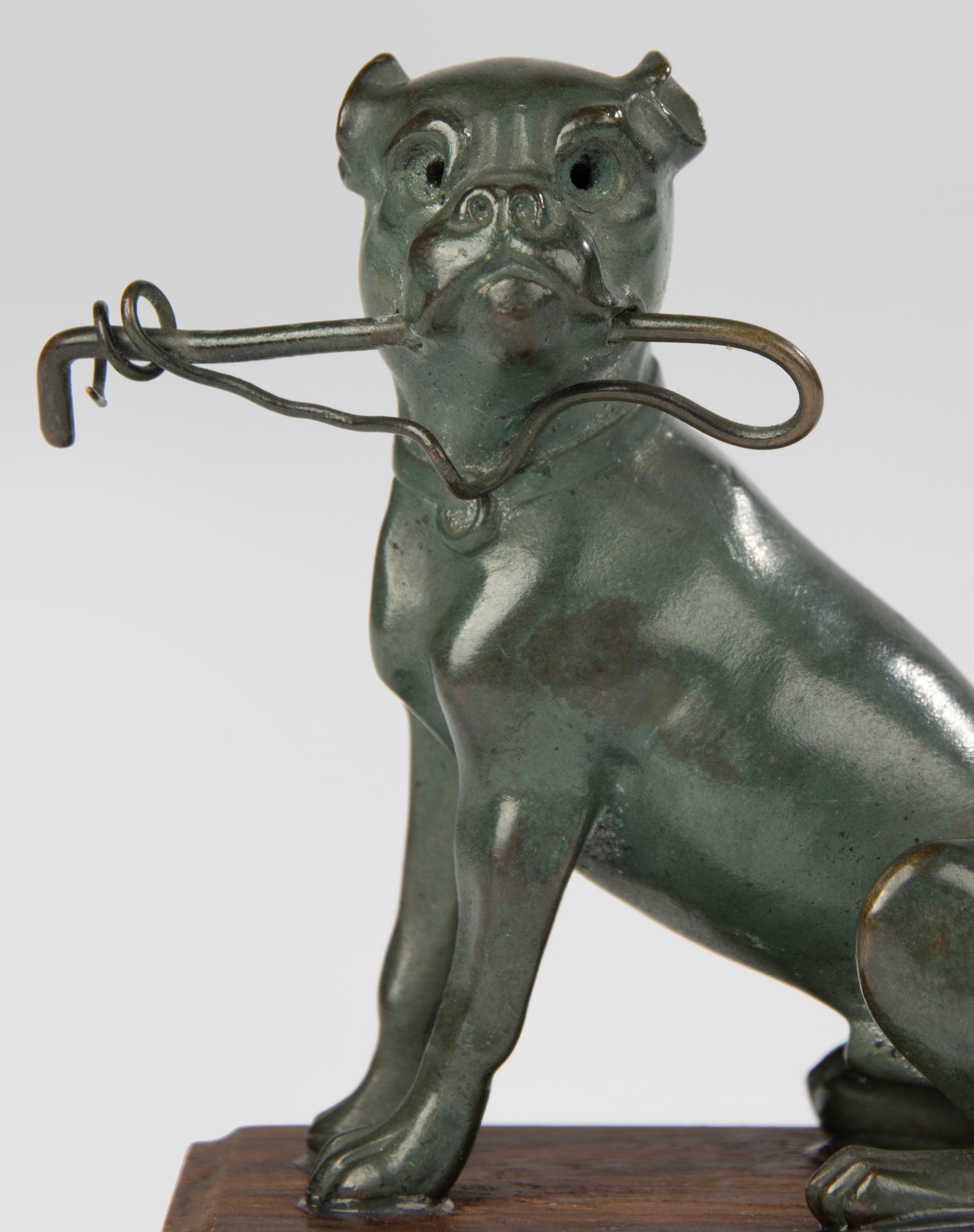 A beautiful small antique bronze statue of a bulldog.
The bronze is patinated in a beautiful green color.
The statue is beautiful in shape and design, beautiful anatomy and posture.
The statue is glued to a wooden base. This is not done very