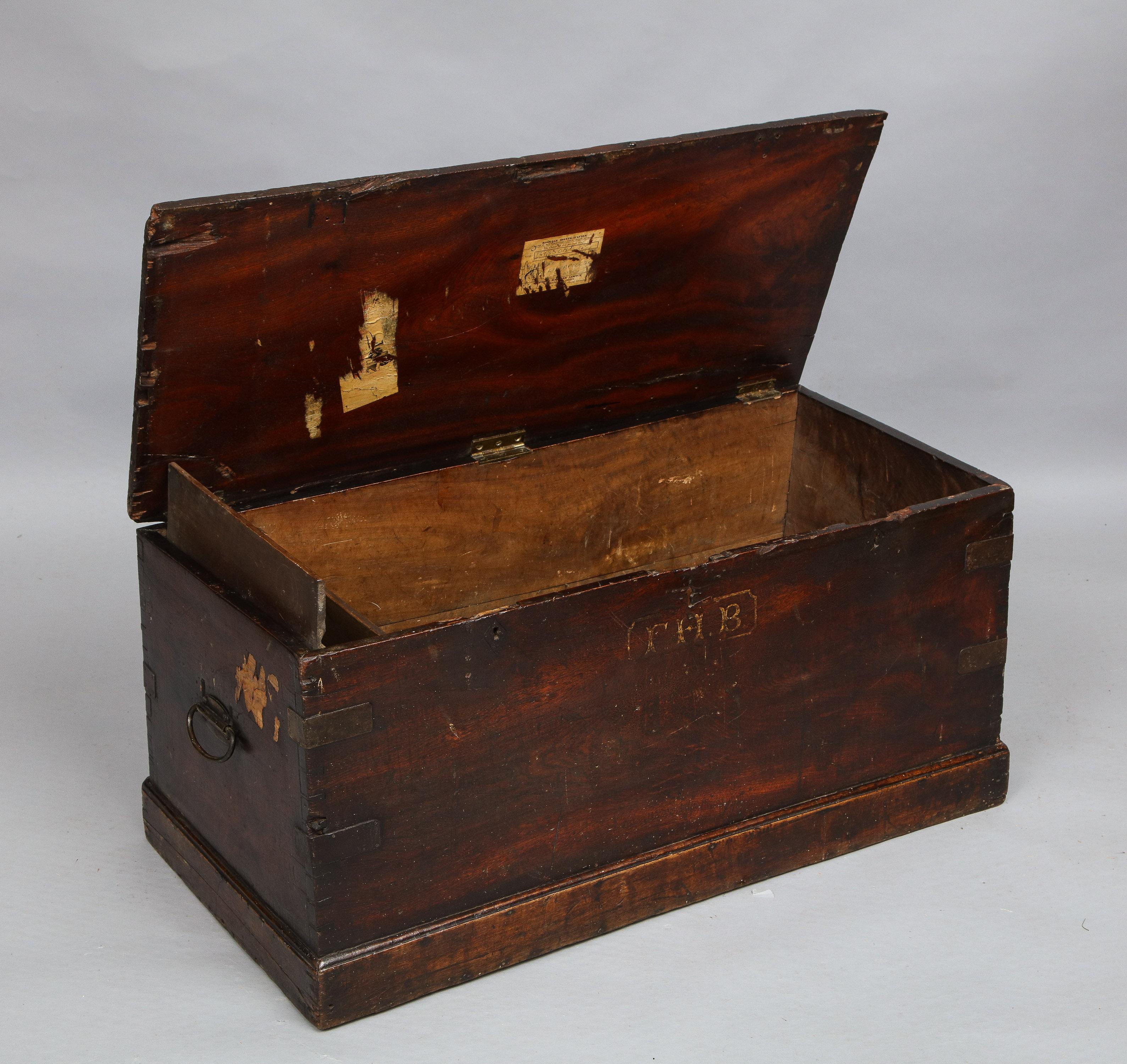 Good 19th century sailor's chest in richly patinated teak, the top opening to reveal a candle till with lid which functions as a support for the open lid, over canted carcass, the corners reinforced with metal plates and dovetail construction,