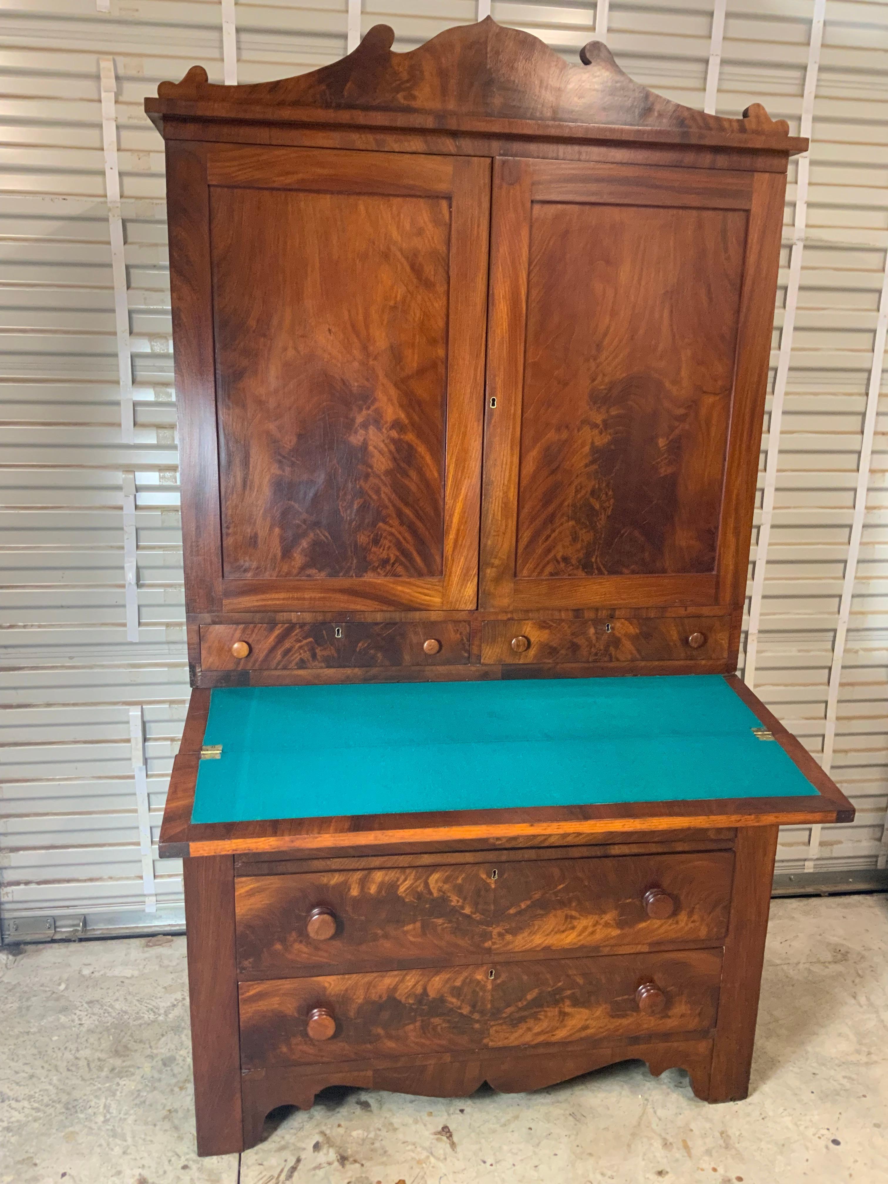 A very handsome late American Empire Mahogany Secretary Desk. Very good condition overall with an old refinished surface exhibiting a beautiful color and patina to the figured Mahogany.  Poplar and white Pine case wood and drawer construction.  All