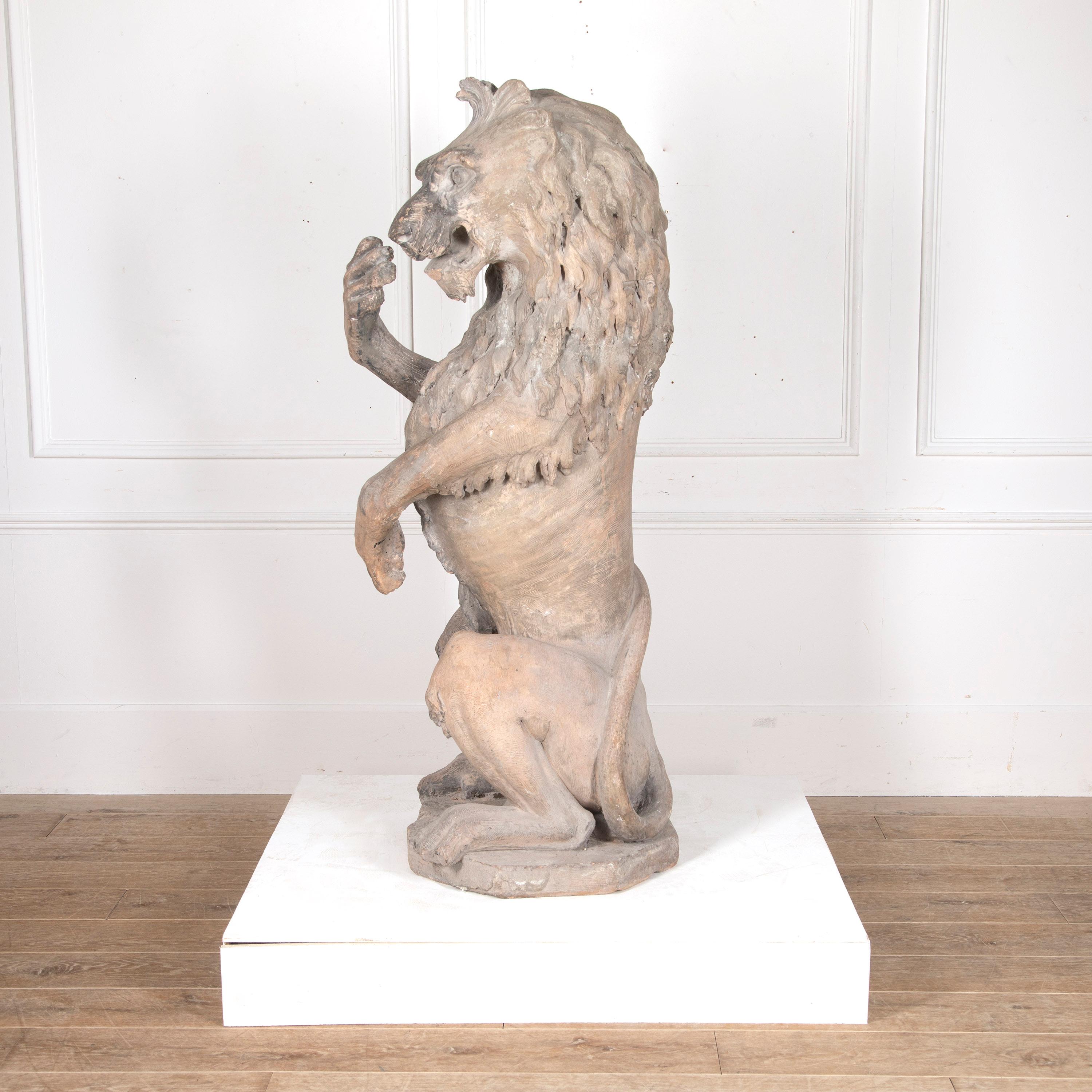 Majestic and huge English 19th Century terracotta figure of a lion.

This magnificent lion is depicted on his haunches in the Sejant-rampant or Sejant-erect pose. 

He is boldly carved all over, with a wonderfully animated face and great detail