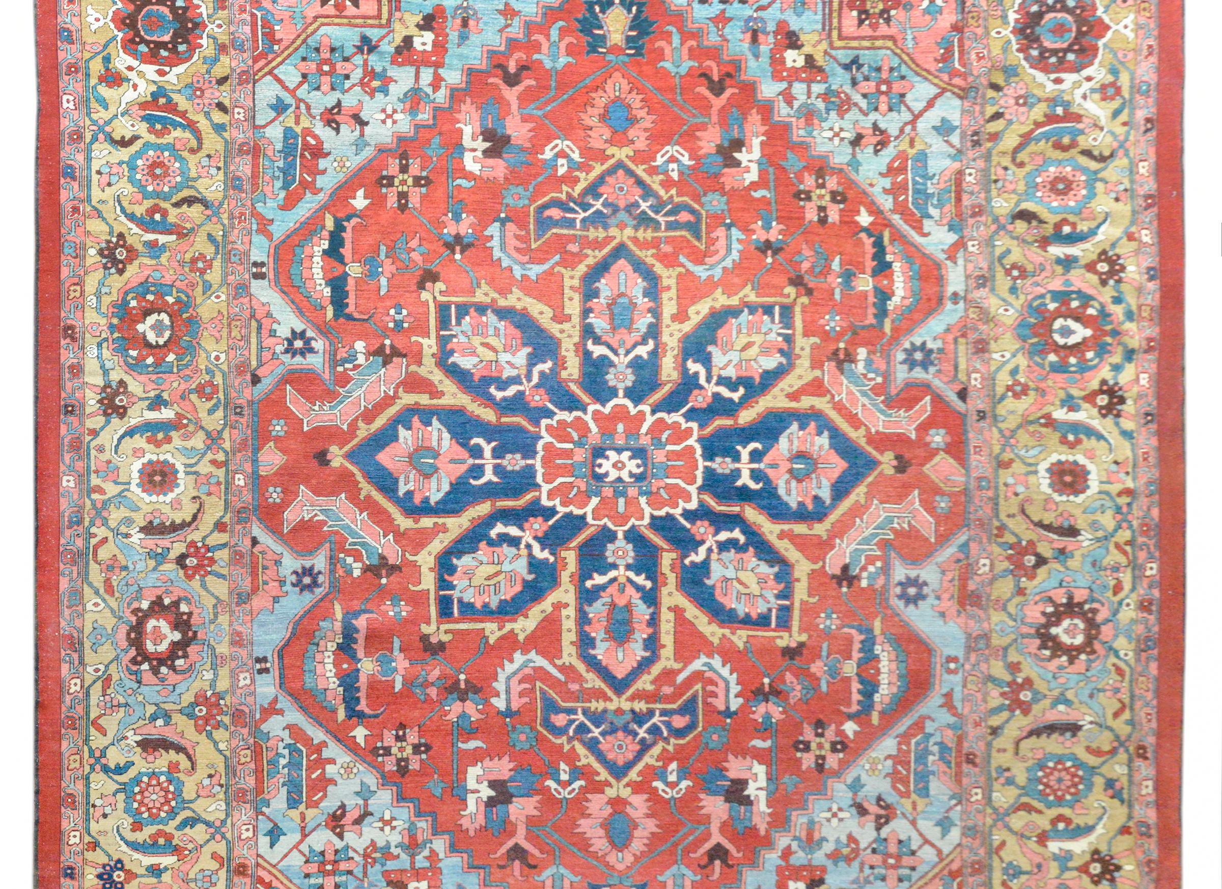 A fantastic late 19th century Persian Serapi rug with a grandiose pattern containing a large indigo eight-lobed medallion woven with a floral pattern, and living amidst a field of more flowers and vines against a bold rich crimson background. The