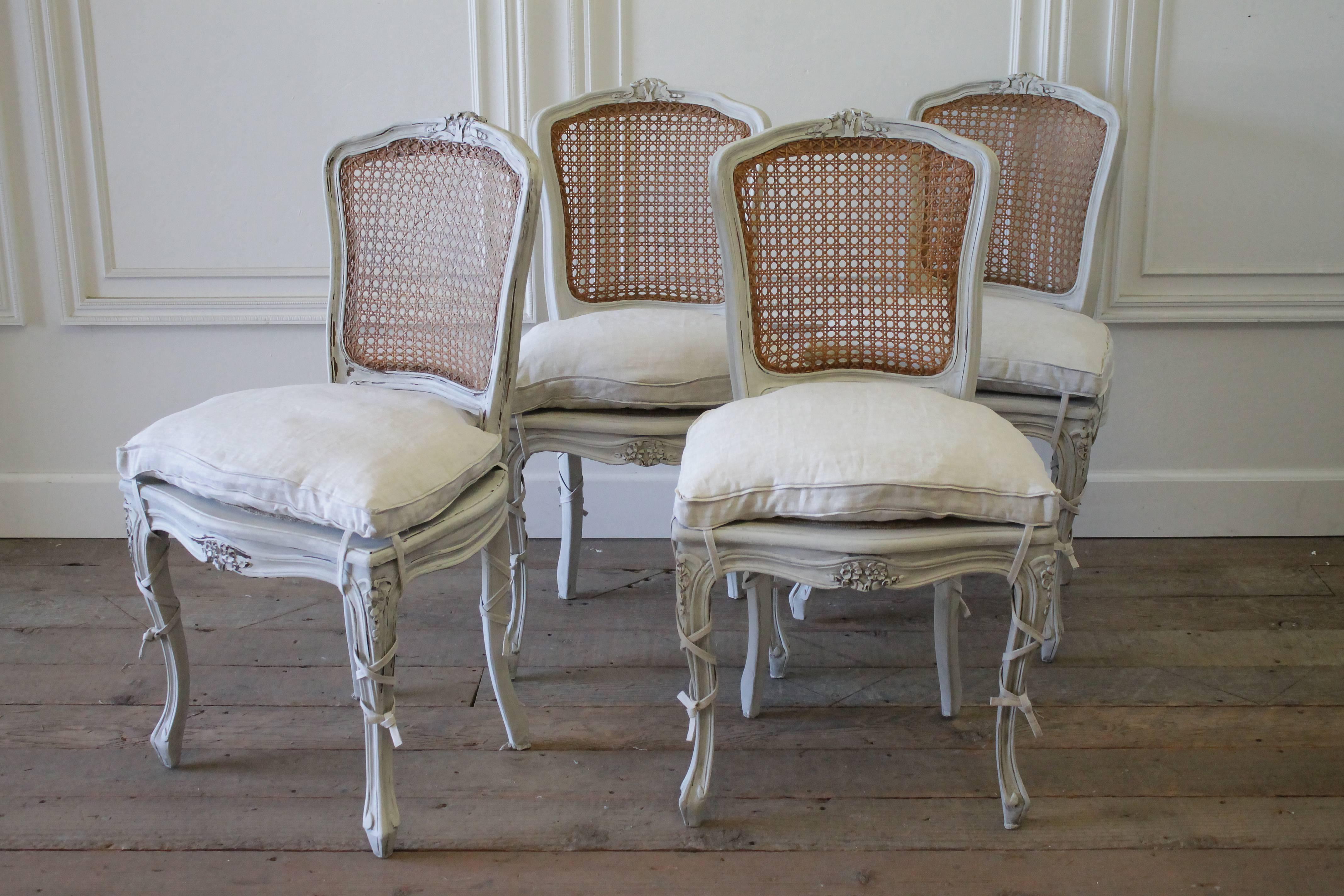 19th century set of four antique French Louis XV style cane back dining chairs
Painted in a soft oyster white, with natural original cane backs, subtle distressed edges, and hand glazed patina.
The custom made seats are sewn from 100% pure Irish
