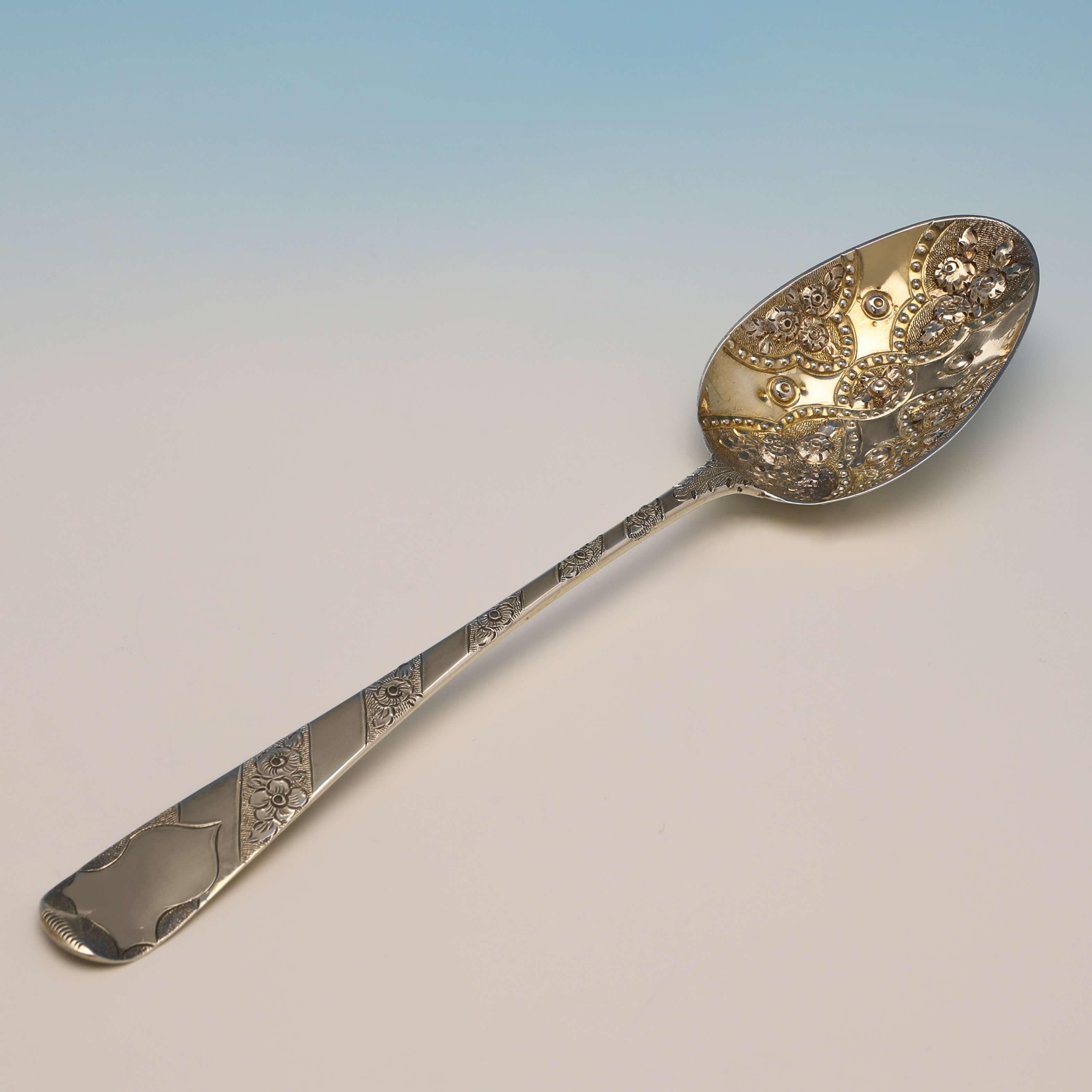 Hallmarked in London in 1809 and 1811 by Peter & William Bateman, this set of 4, antique sterling silver berry spoons, are presented in a box, and feature cashed bowls, engraved handles, and gilding. 

Each berry spoon measures 8.5