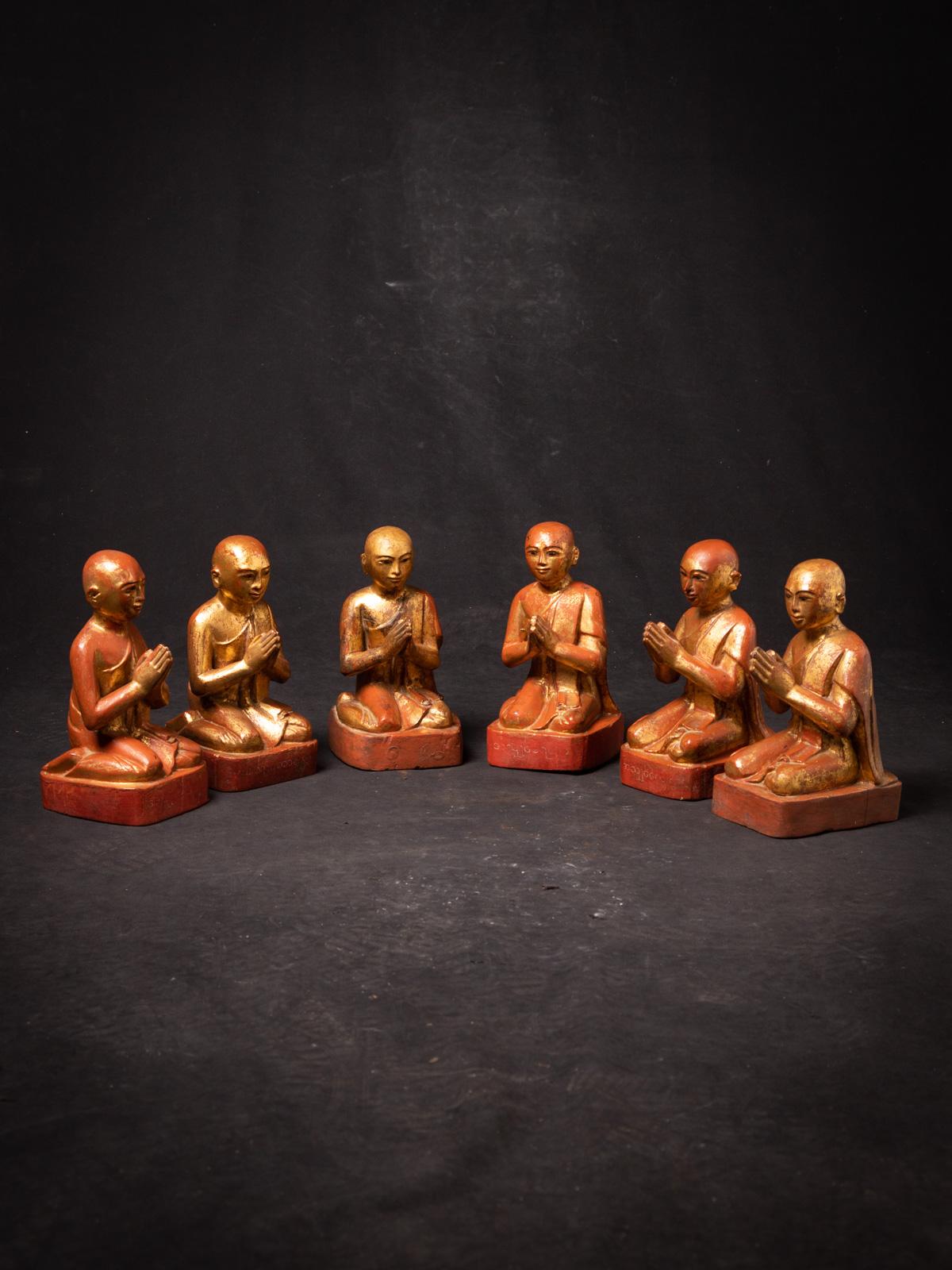 The set of 6 antique wooden Burmese Monk statues is a captivating ensemble that encapsulates the spiritual and artistic essence of Burma. Crafted from wood and adorned with gilding in 24-karat gold, these statues stand at a height of 23.5 cm, with