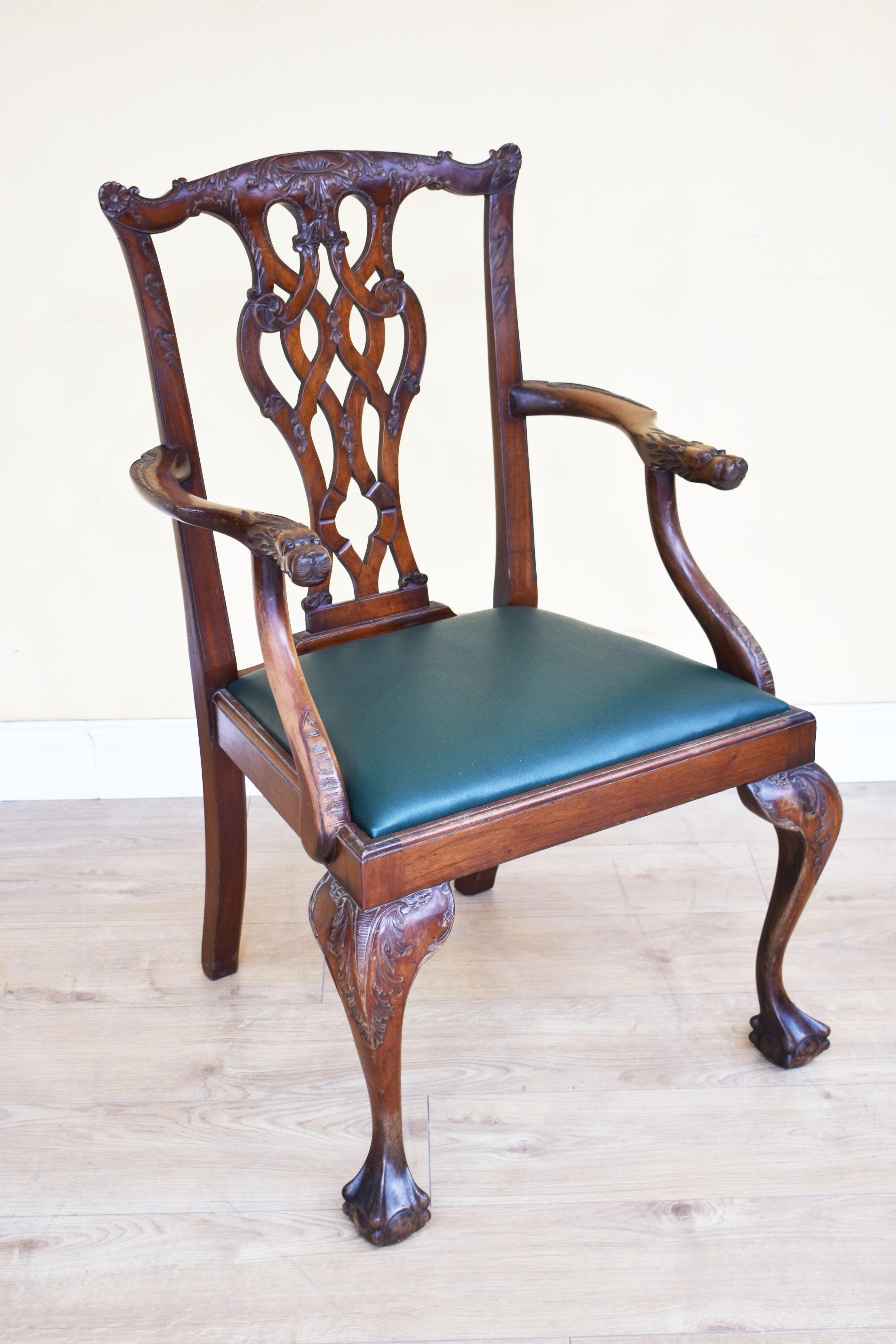 For sale is a good quality set of 6 carved mahogany Chippendale style dining chairs. Each having ornate carved backs and carved lion heads on the arms, with drop in seats, raised on elegant carved cabriole legs terminating on claw and ball feet. All