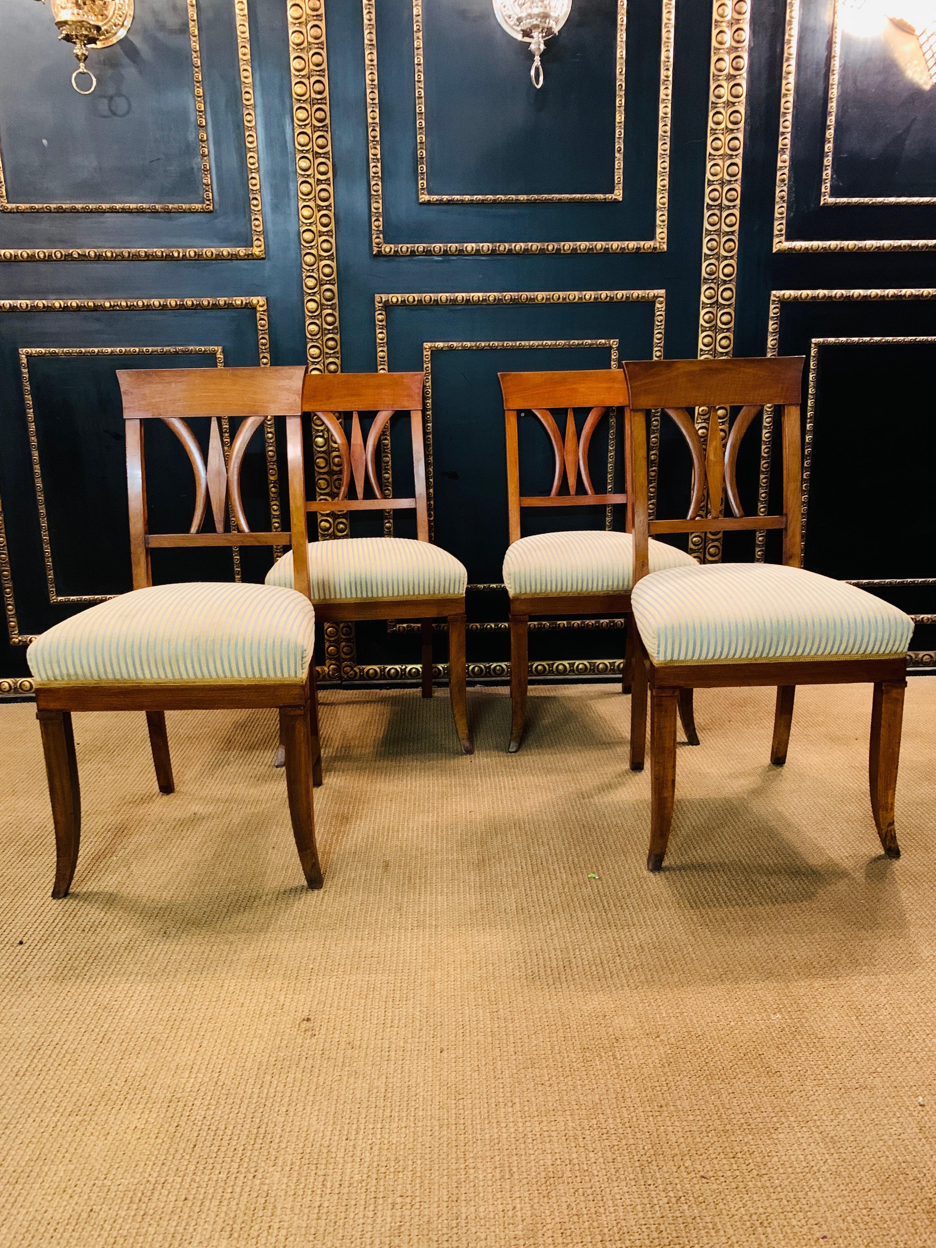 Beautiful set of Biedermeier chairs, circa 1820. Solid cheerywood. Slightly arched backrest with straight top and middle bridge. upholstered seat and covered with a fabric. These chairs have been completely restored by an experienced restorer not so