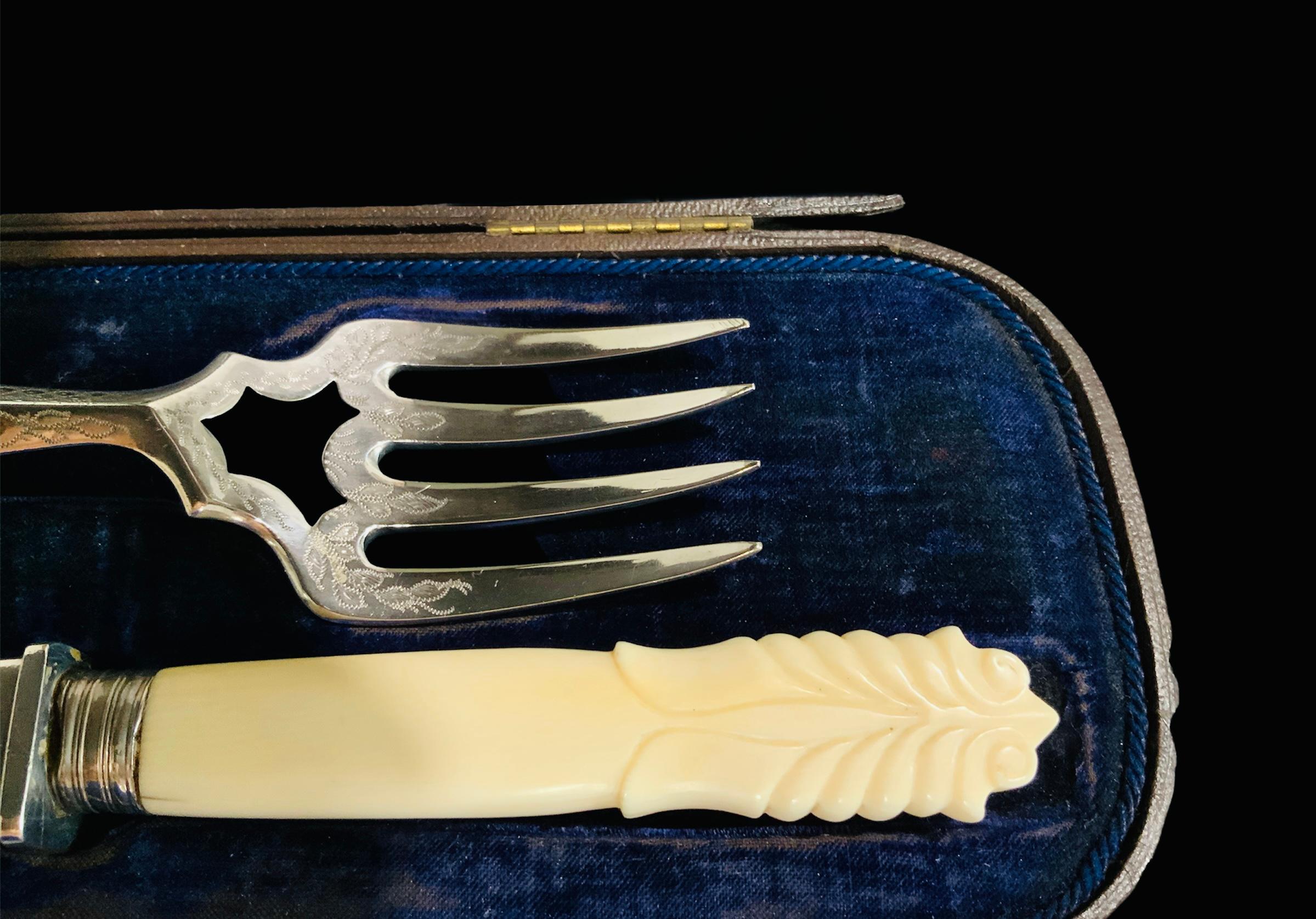 This is a 19th century English set of fish serving fork and knife. They could be or could not be sterling silver, but I am unable to test them. Their handles are made of ivory like material and their tops are shaped as scrolls of acanthus leaves.