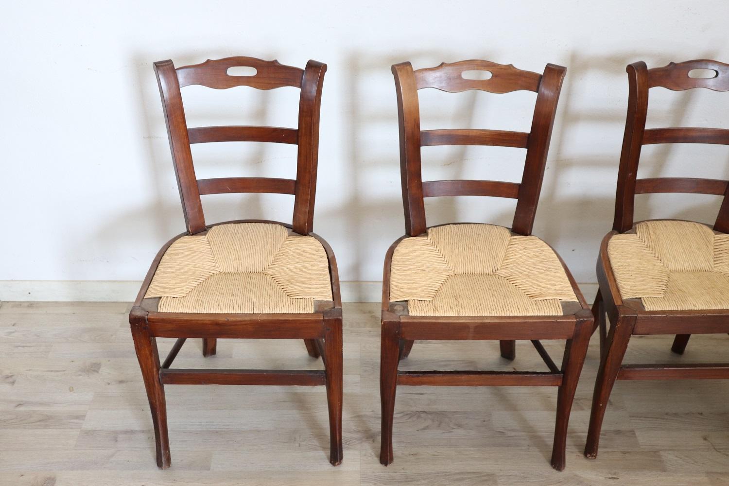 19th Century dining room set of four antique chairs in solid cherry wood. The chairs are very elegant with very slender and solid moving legs. The seat is wide and comfortable in rustic straw. The chairs are in perfect condition ready to be used in