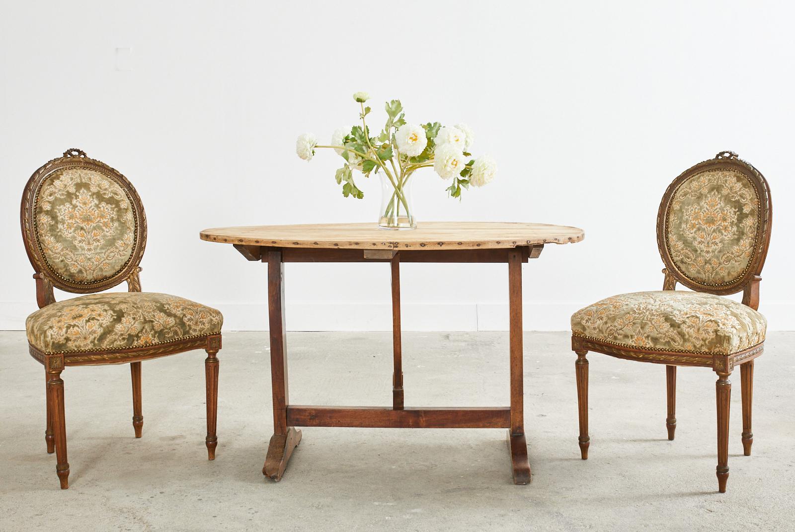 Classic set of 19th century French dining chairs crafted from mahogany. The set consists of two armchairs and two side chairs the later measuring 21