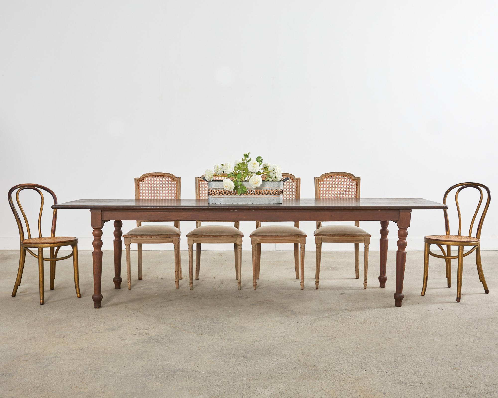 Gorgeous weathered set of four painted 19th century dining chairs made in the Swedish Gustavian taste. The chairs feature a carved frame with an arched caned back. The seats have a bowed front and have been recently upholstered with a linen fabric