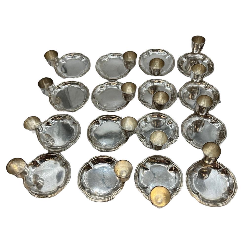 Introducing a remarkable set of sixteen Spanish Sterling silver dishes, each thoughtfully designed with an attached portion cup. These exquisite pieces are crafted from Spanish 915 silver, showcasing an artful combination of functionality and