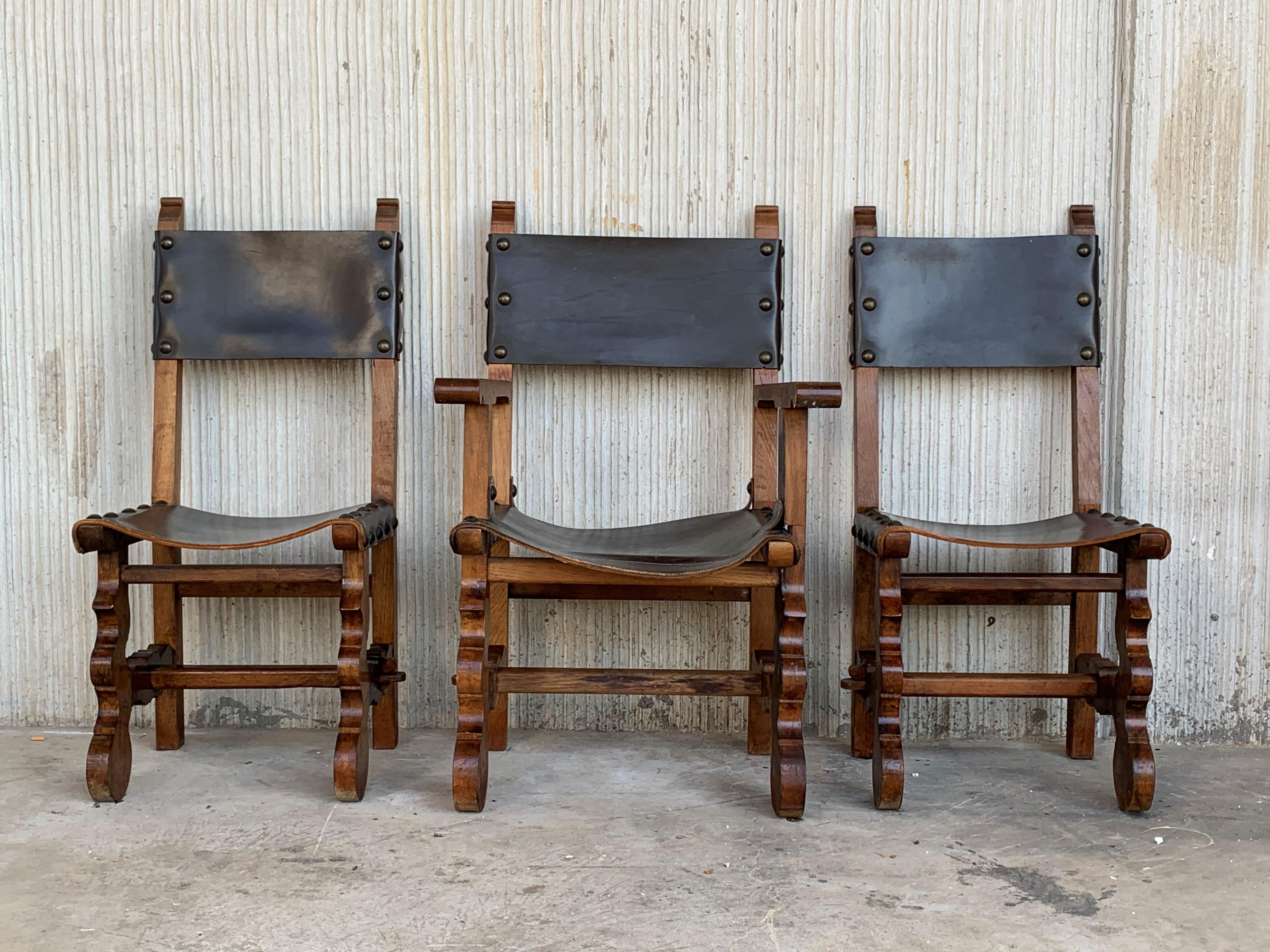 Pair of Spanish Colonial style chairs and armchair, having leather both seats and backs, and brass nailheads.


Armchair measurements:
Height 39.37in, seat height 18in, height to the arm 26.77in
Wide 17.71in
Deep 15.75in

Chair