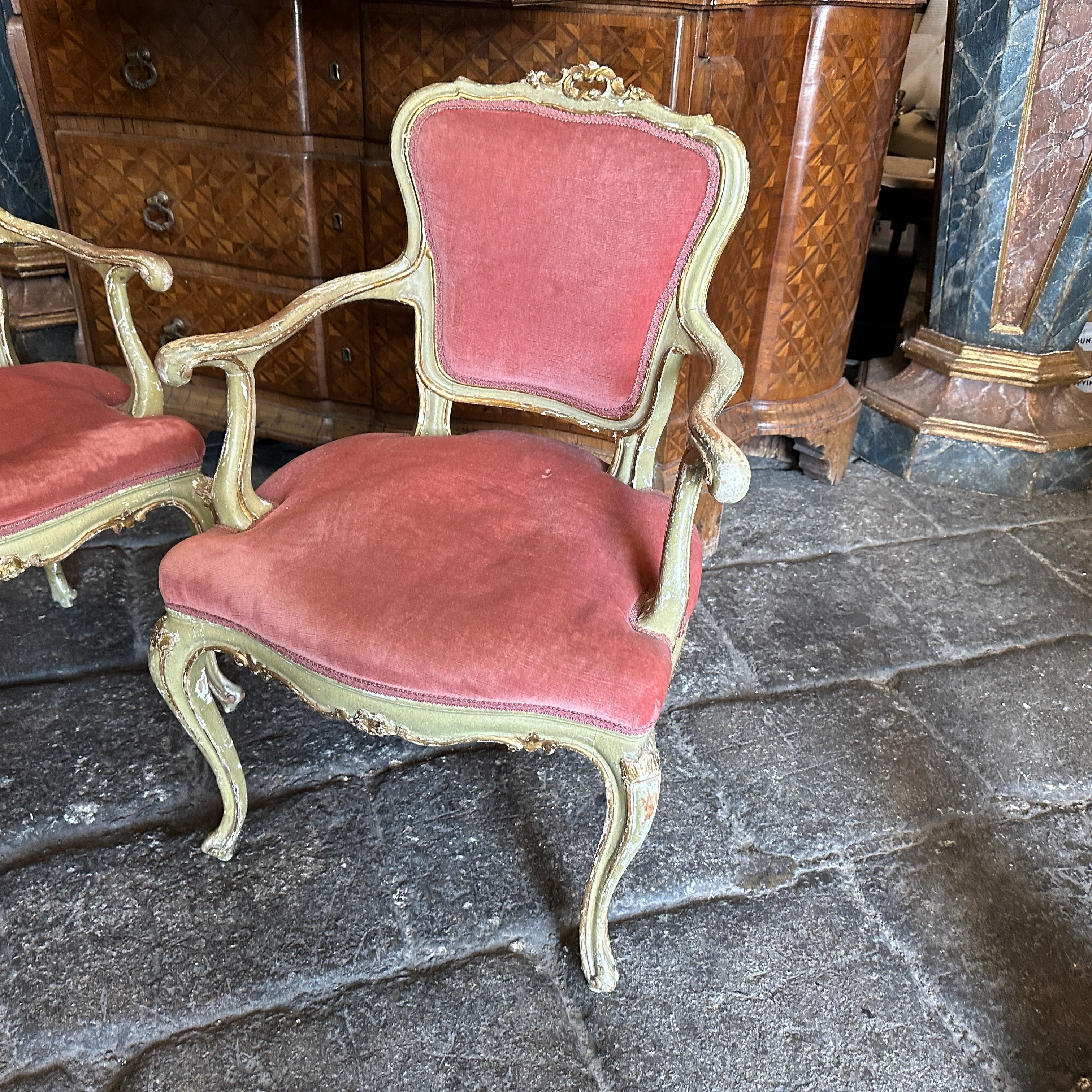 A 19th-century set of two green lacquered wood Venetian armchairs exudes elegance and craftsmanship typical of the period. These armchairs, originating from Venice during the 1800s, boast intricate designs and attention to detail, they are in