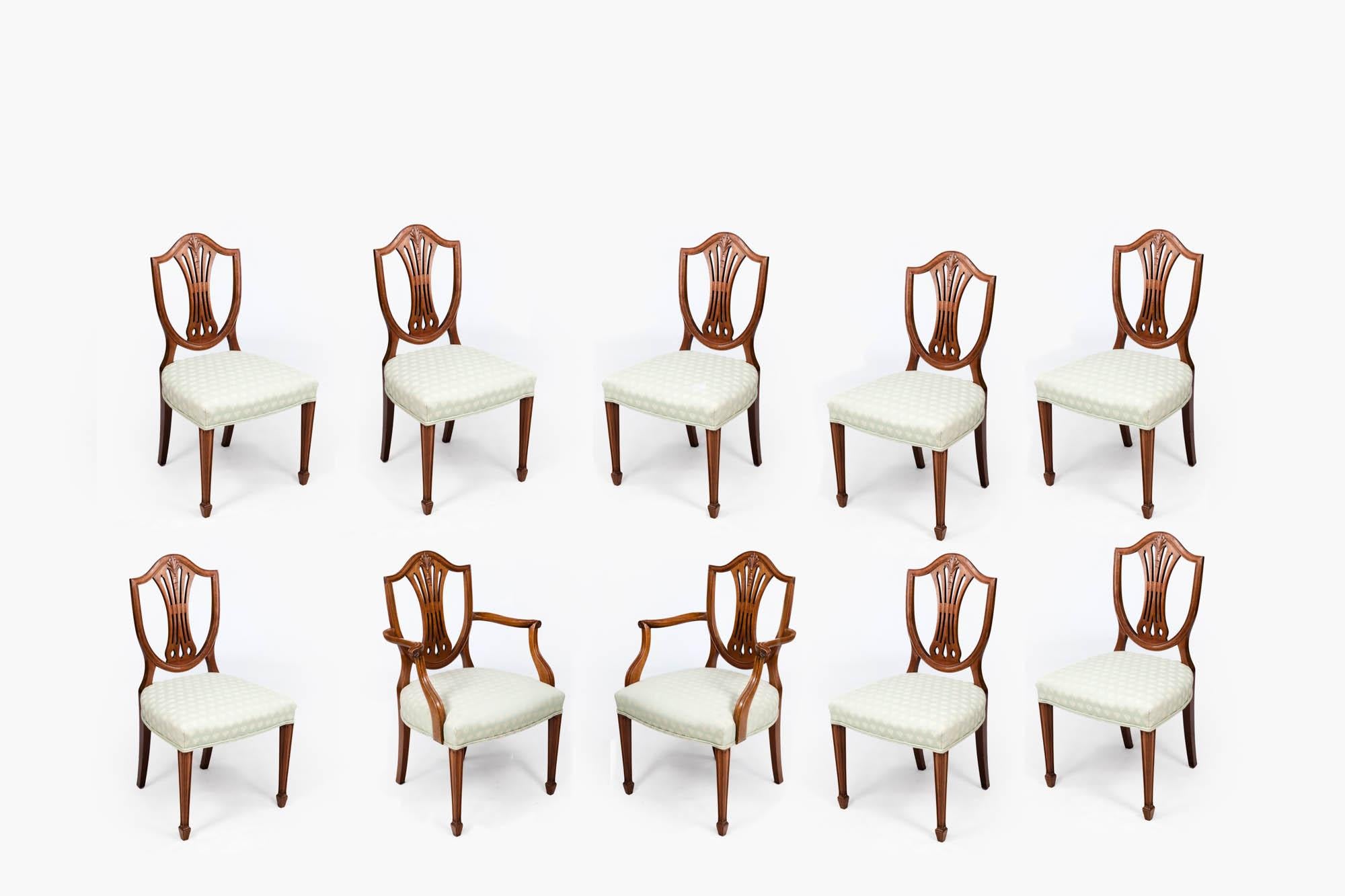 19th century set of ten shield-back dining chairs (eight + two carvers). In the elegant style of Hepplewhite. The 'Hepplewhite' chair is a highly distinctive style of light, elegant furniture that was highly fashionable between 1775 - 1800.