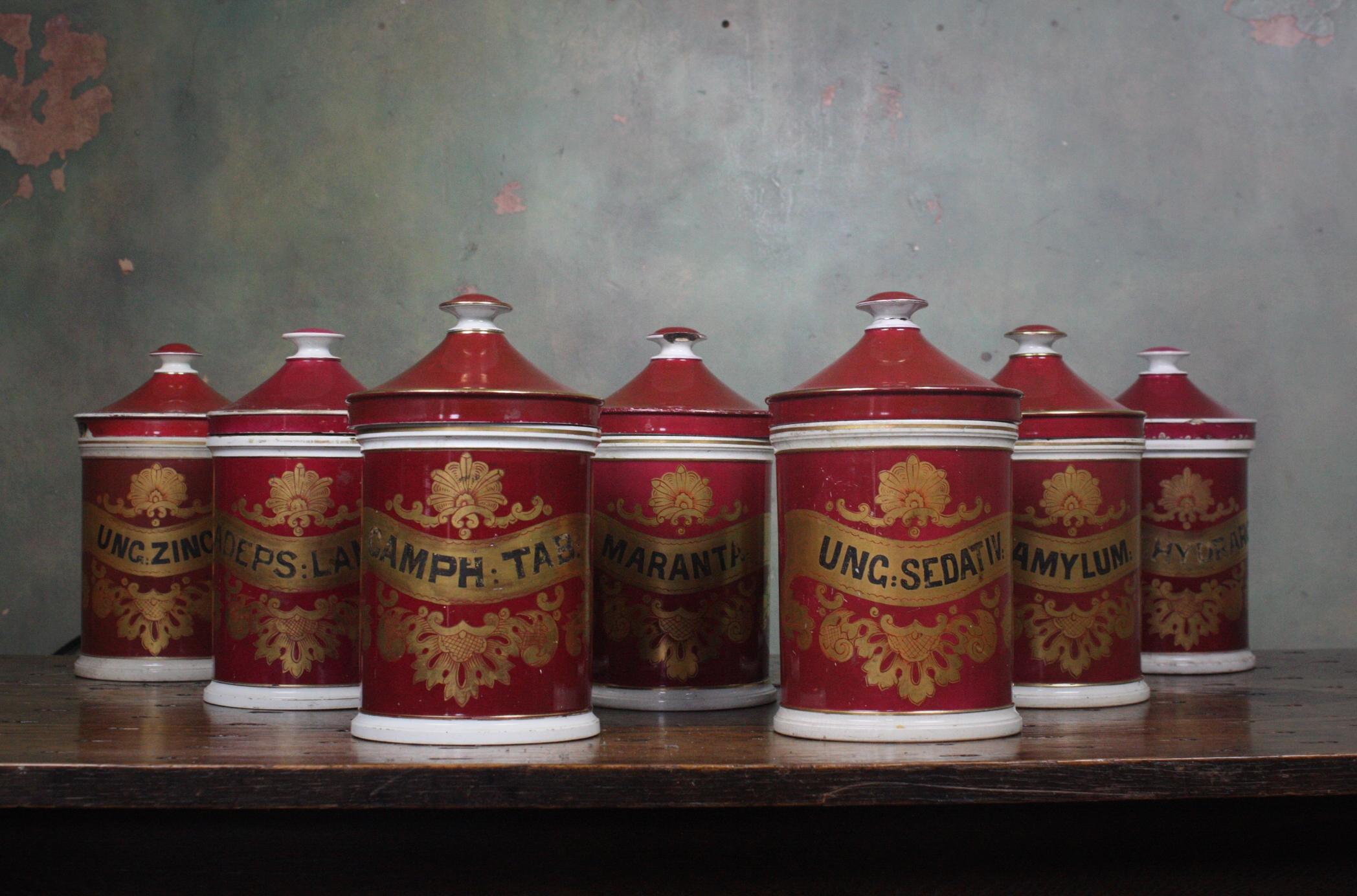 Rare collection of seven crimson red stoneware and glazed dispensing jars with hand painting gilt labels

These where made by Mottershead & Co of Manchester Established 1790 

circa 1850 in age 

Three lids are damaged, with elderly repairs.