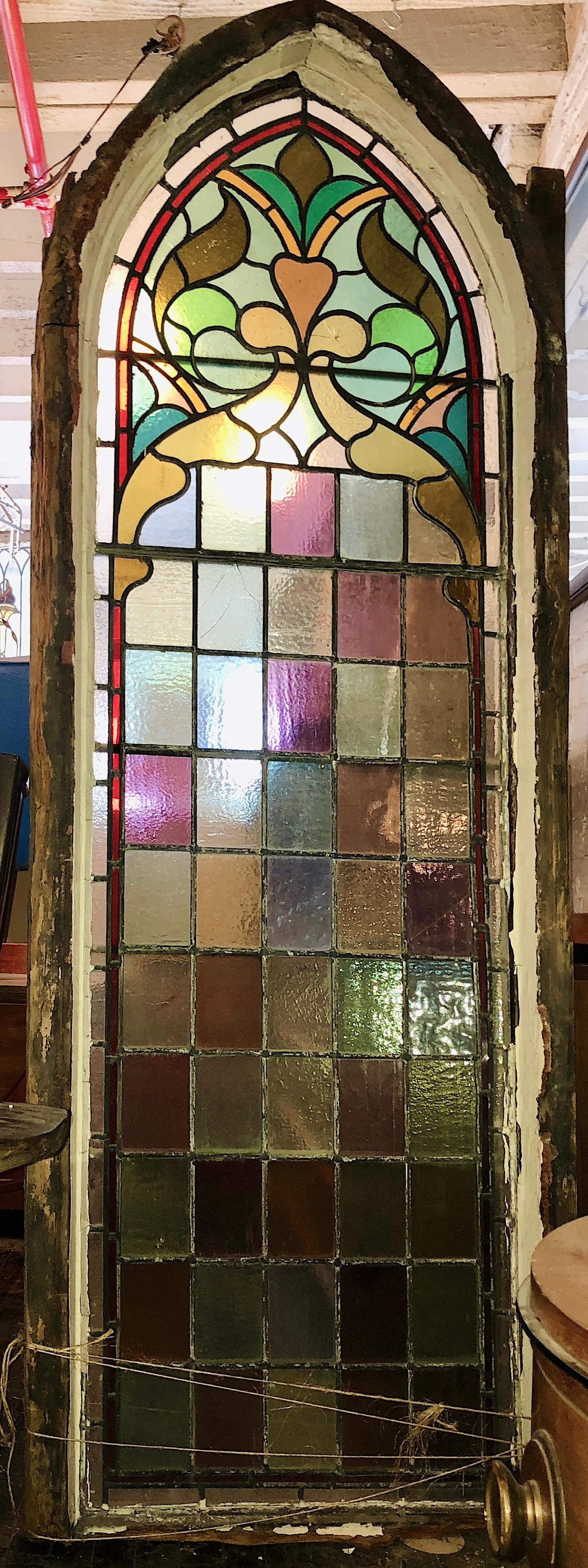Large antique church window with traditional harlequin pattern and pointed arch. This window came from a 19th Century church before its demolition. Magnificent colored glass and leaded designs.
The overall dimensions are for the stained glass and