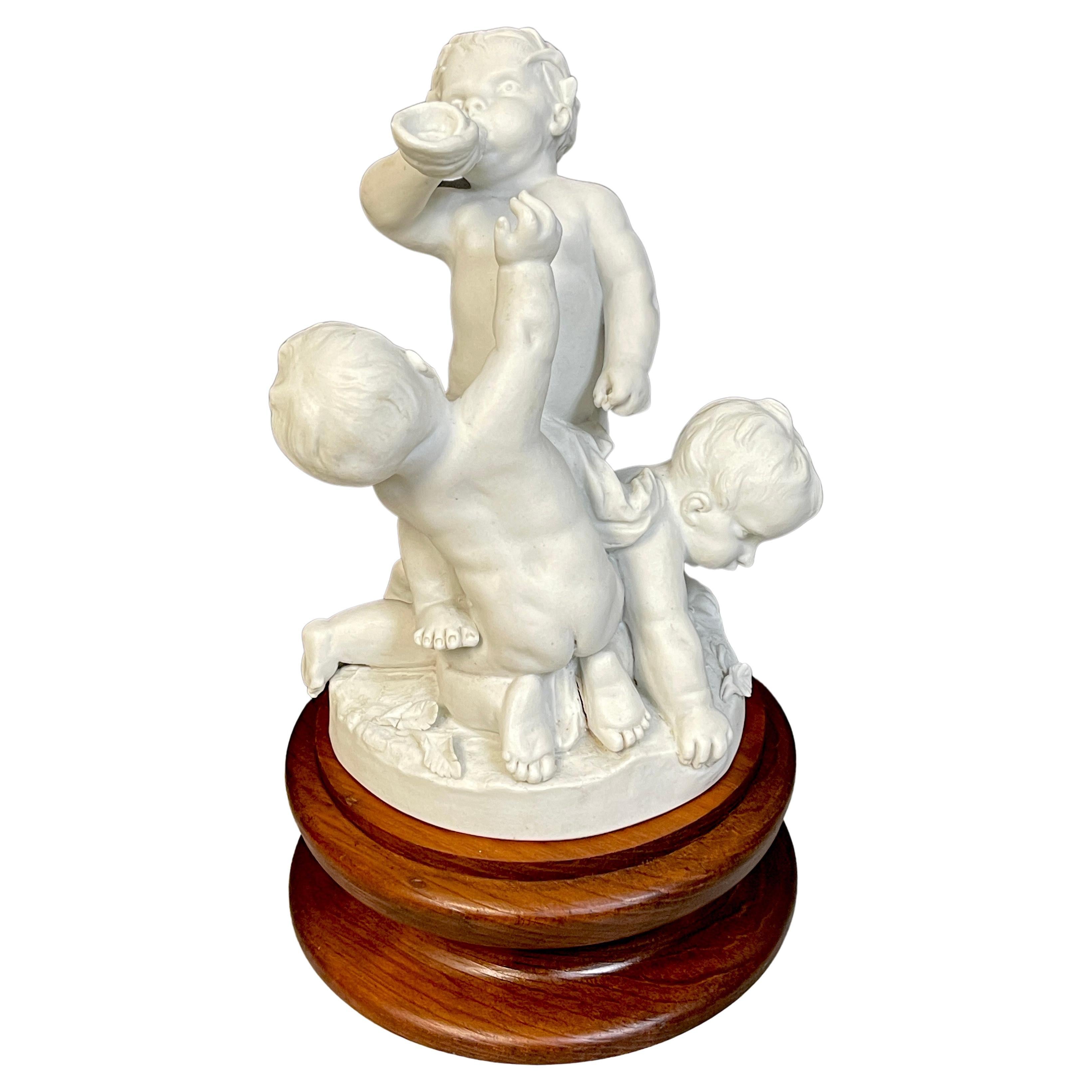 19th Century Sevres Biscuit Group of Three Frolicking Puttos For Sale