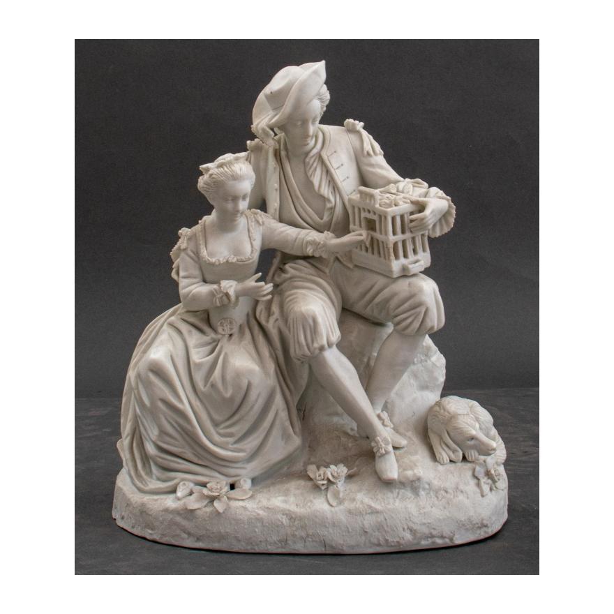 French Sevres style white glazed bisque porcelain decorative figural genre group in the manner of Michel Victor Acier ( French, 1736-1799 ) depicting a gallant and his lady coaxing a bird from its cage on a field of roses. The sculpture is in great