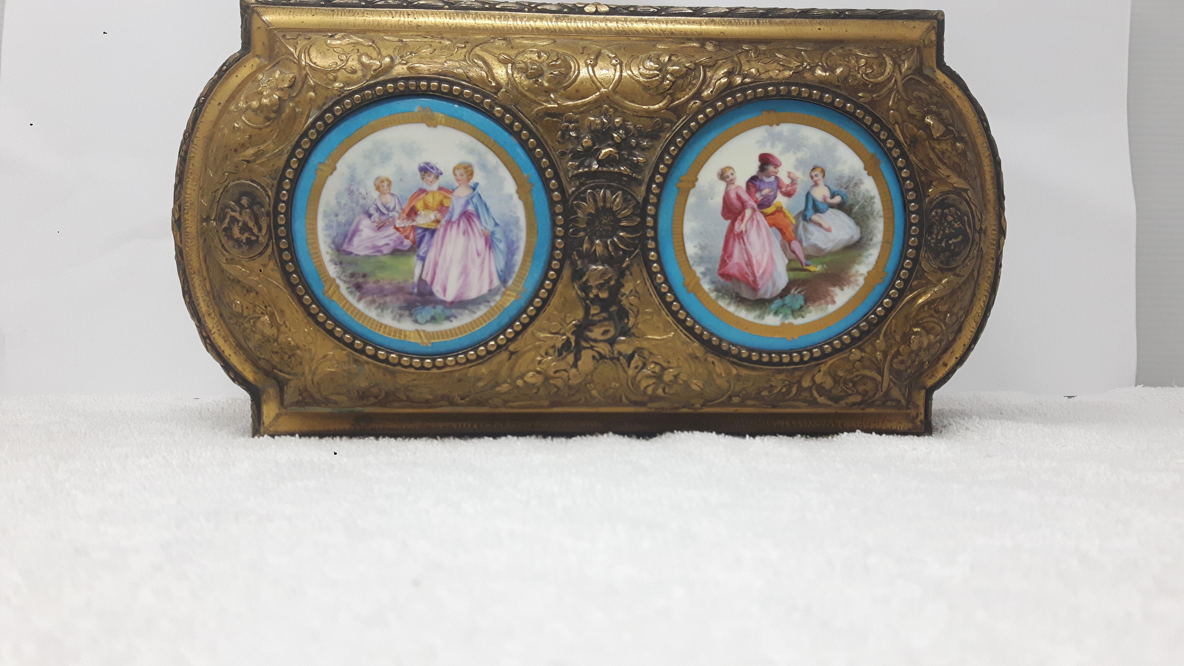 19th century French Sevres style ormolu and porcelain casket having
light blue ground, painted with panels of romantic scenes.