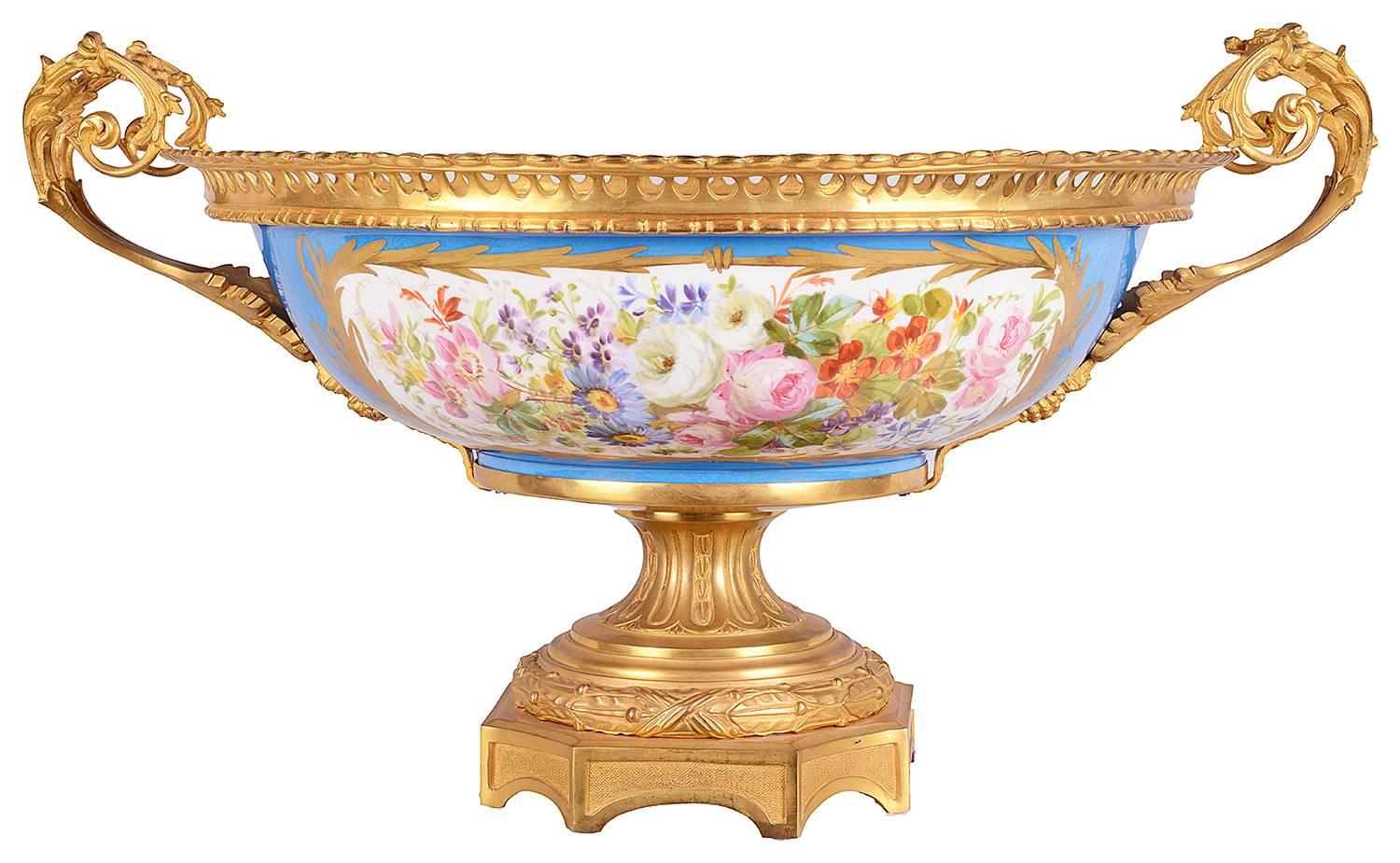 A good quality 19th century French Sevres style gilded ormolu-mounted comport. Having a classical romantic scene to the central panel, with a light blue coloured ground, gilded decoration, a floral scene to the reverse. Scrolling gilded foliate