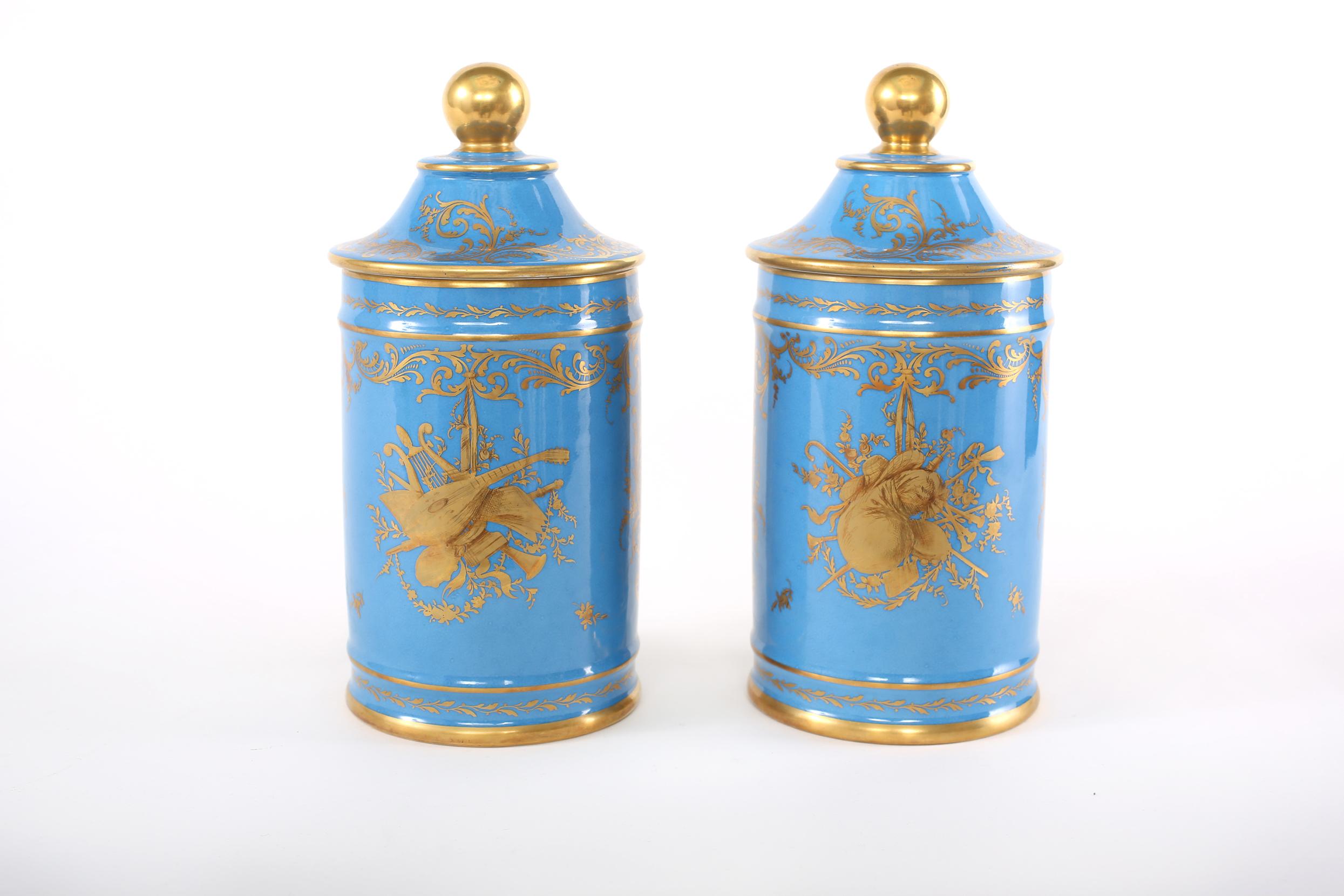 Mid 19th century pair of Sevres-style gilt porcelain covered jars with exterior painted scene design details. Each piece is in good condition. Minor wear consistent with age / use. Maker's mark undersigned. Each piece / jar stands about 12-1/4