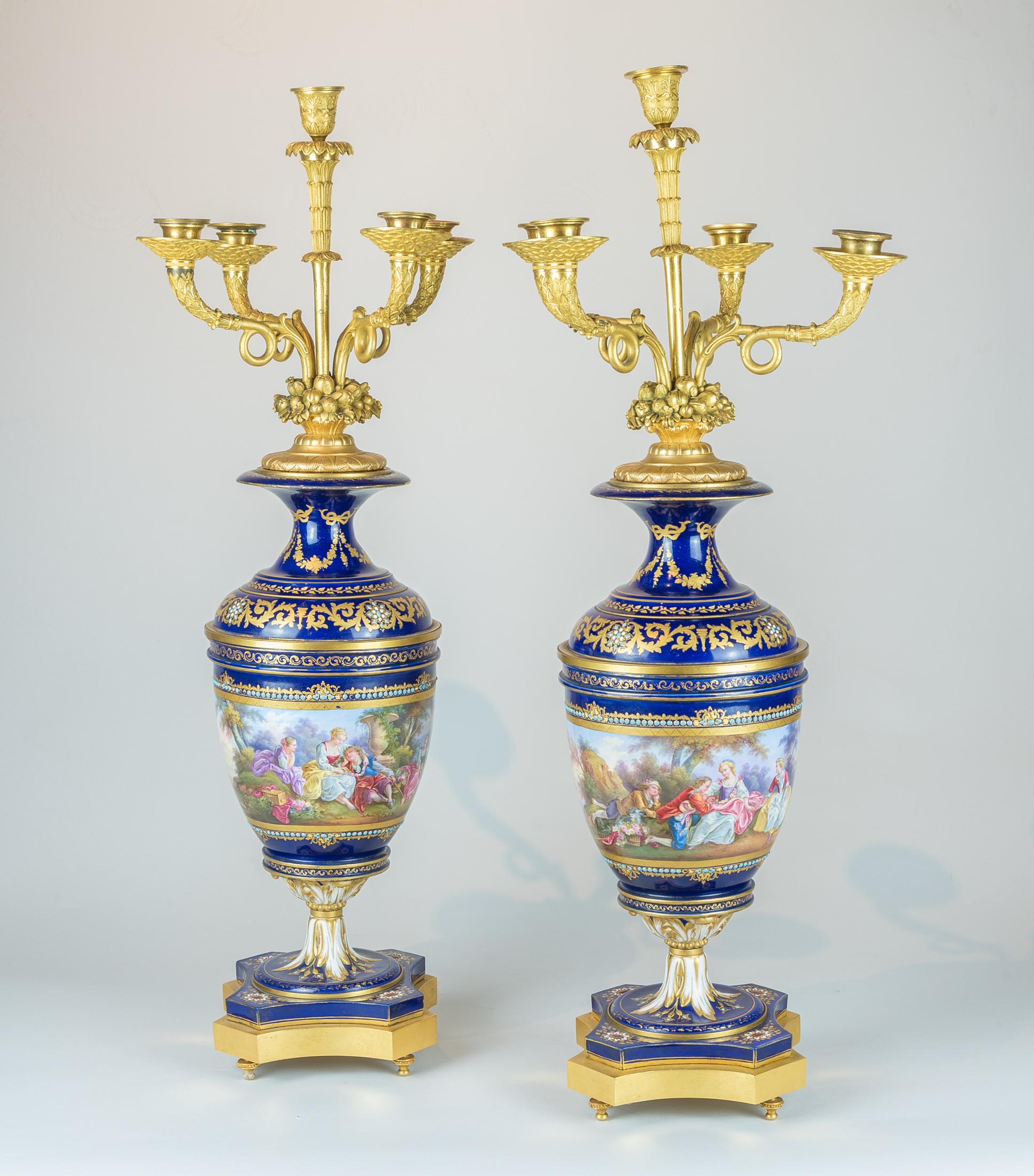 An exquisite 19th century French gilt bronze and hand painted jeweled Sevres Porcelain clock set.
Fine gilt bronze and hand painted jeweled porcelain Sevres royal blue clock set. 

Origin: French
Date: circa 1890
Dimension: Clock 28 1/2 in X 22