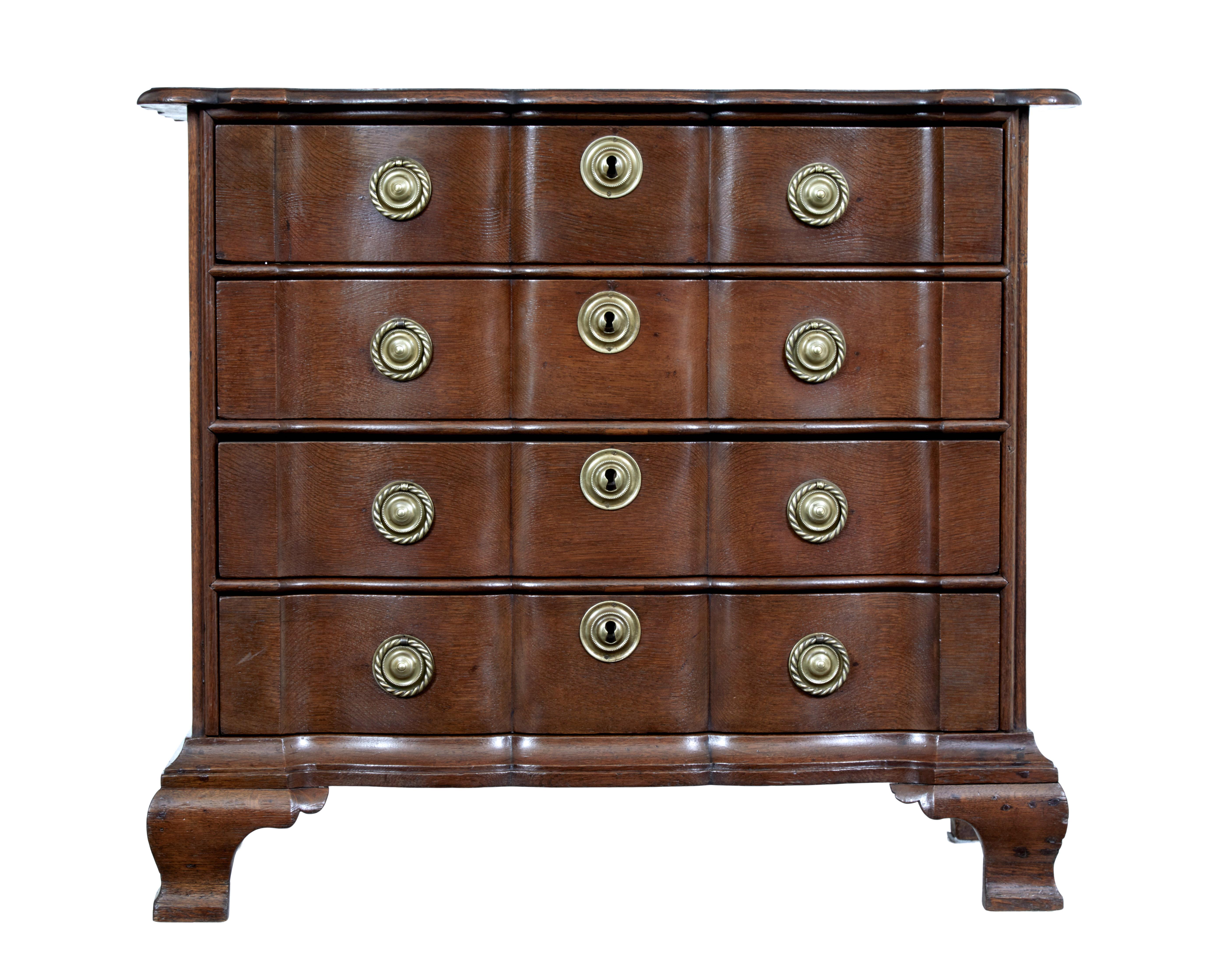 19th century shaped front oak chest of drawers circa 1880.

Dutch shaped oak chest of drawers commode with its serpentine fronted commode very much in the Dutch taste. 4 drawers with original brass rope ring handles and escutcheons.

Standing on