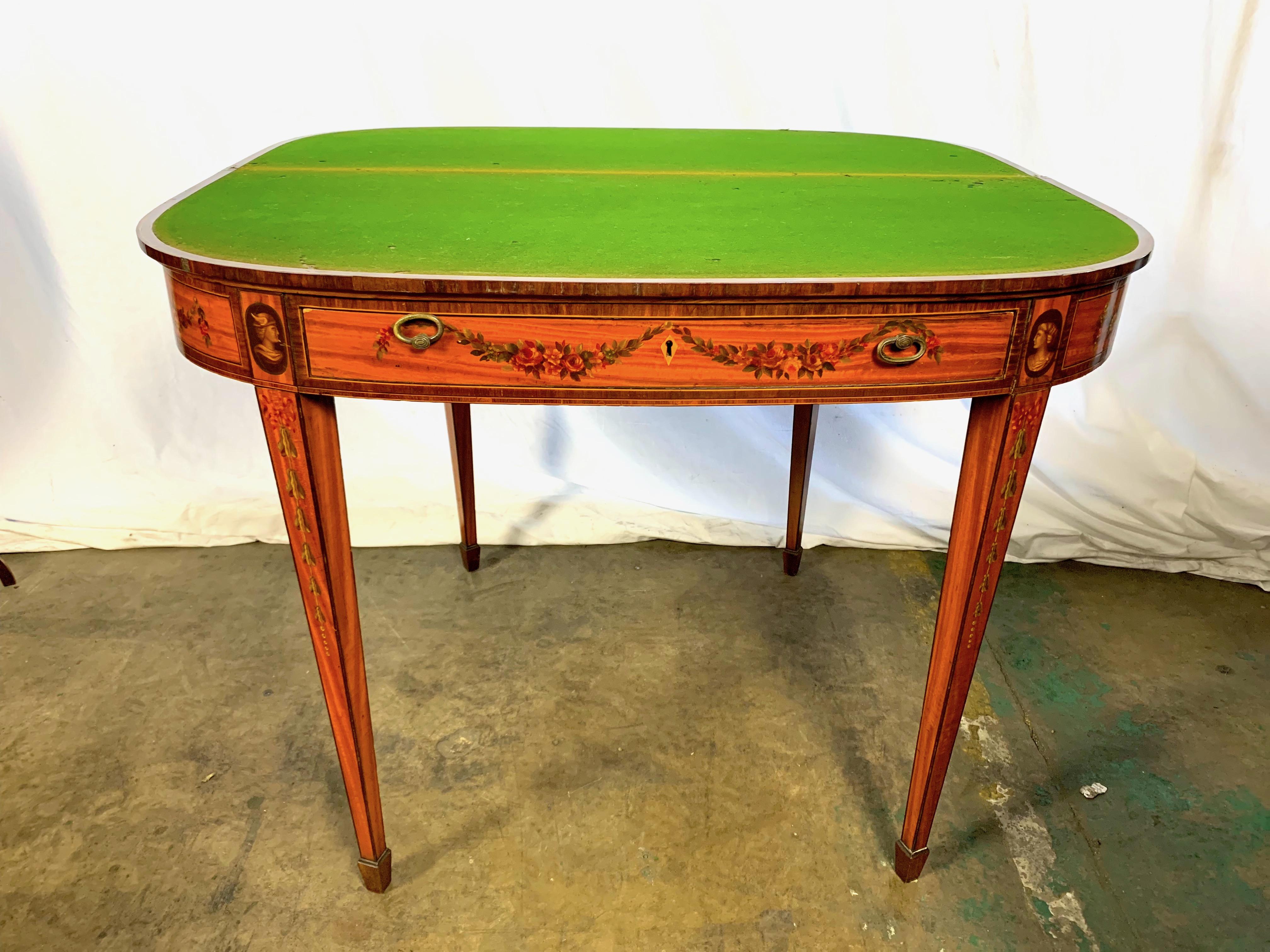 A particularly fine, Victorian, satinwood demilune card table with finely painted foliage and cross banded with floral motifs and central plaque painted of a lady surrounded by Cherubs.