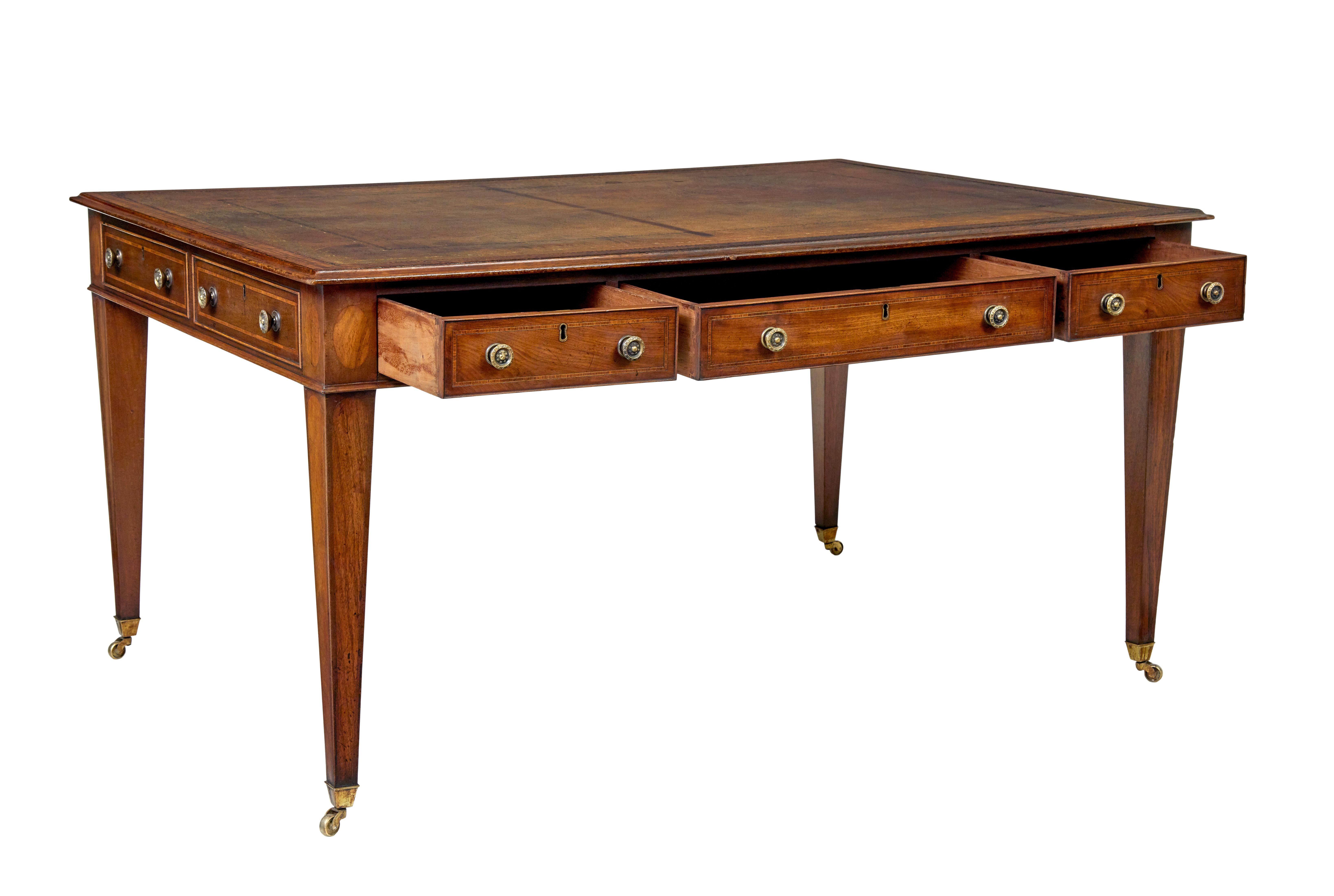 19th century Sheraton revival leather top library table circa 1890.

We are pleased to offer this free standing mahogany writing desk in the sheraton taste.

Original brown leather top with multiple borders of black and gold tooling, strung border