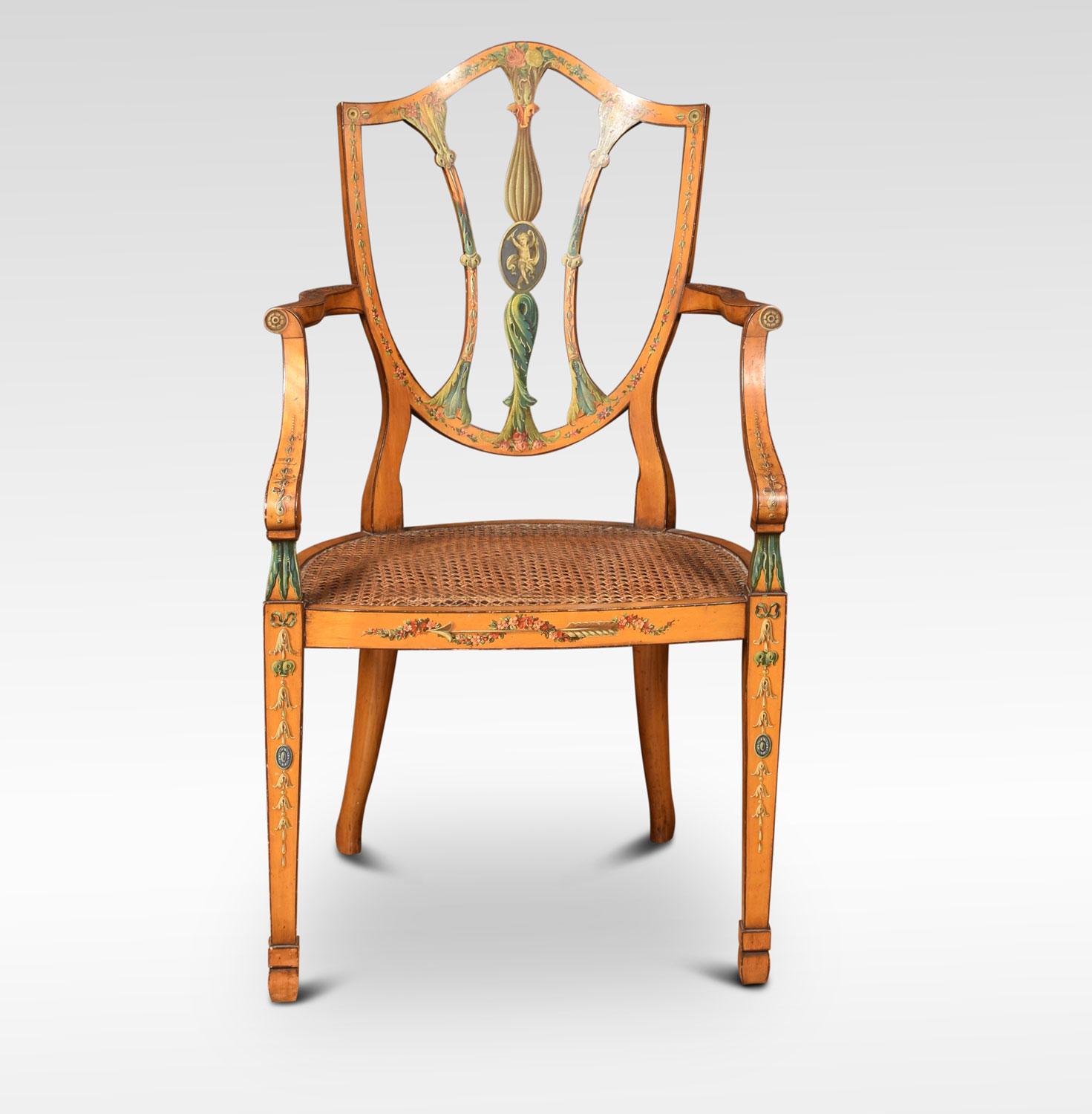 19th century Sheraton Revival satinwood elbow chair, painted overall with flowers and leaves, the shield shaped back with pierced splat and down swept arms, flanking the original inset bergere seat with removable cushion. All raised up on tapering