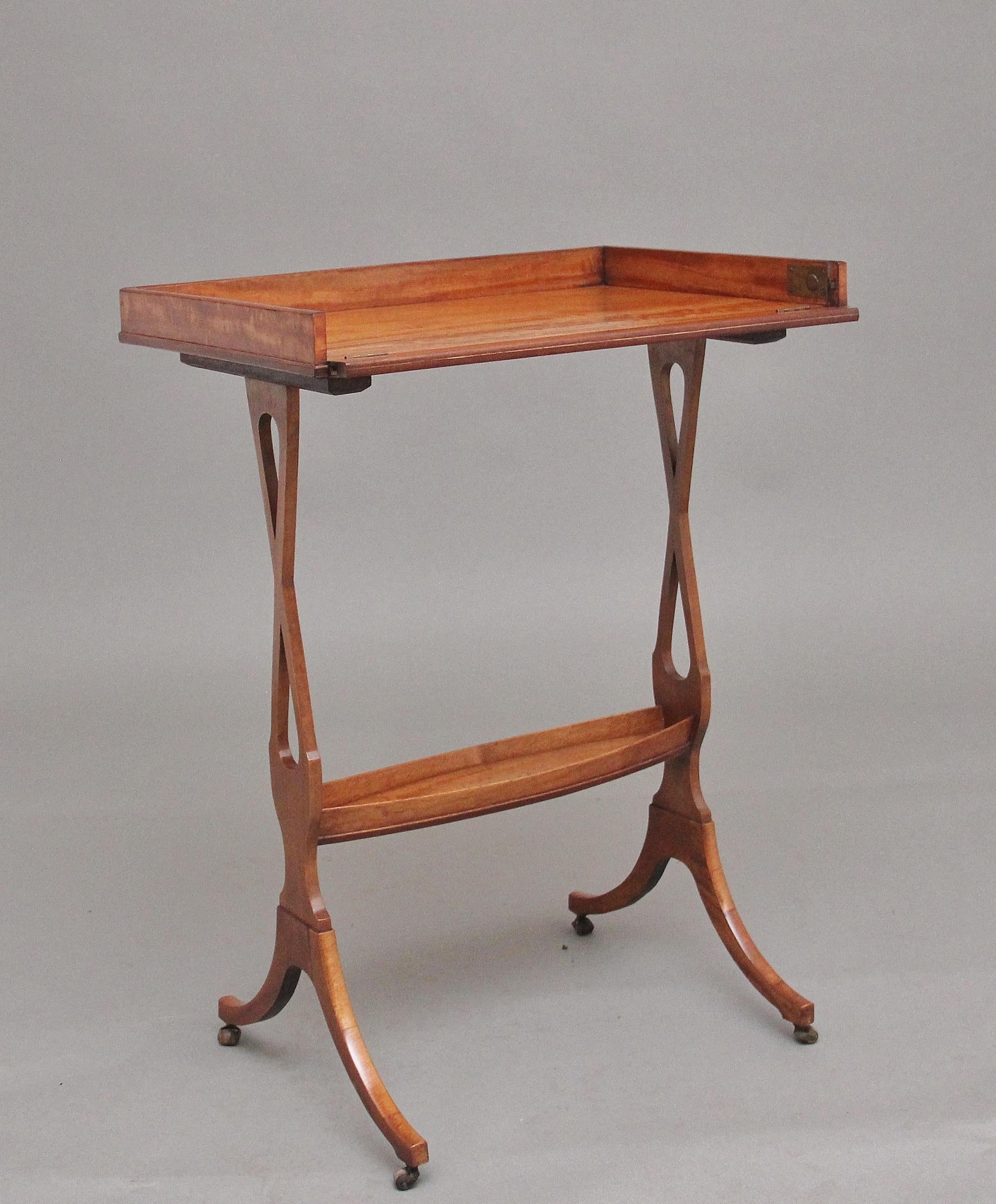 19th Century Sheraton Revival satinwood serving / drinks table, having a nice figured top with a gallery with a hinged drop down side, supported on slender lyre-shaped supports united with a shelf stretcher, terminating on elegant shaped legs with
