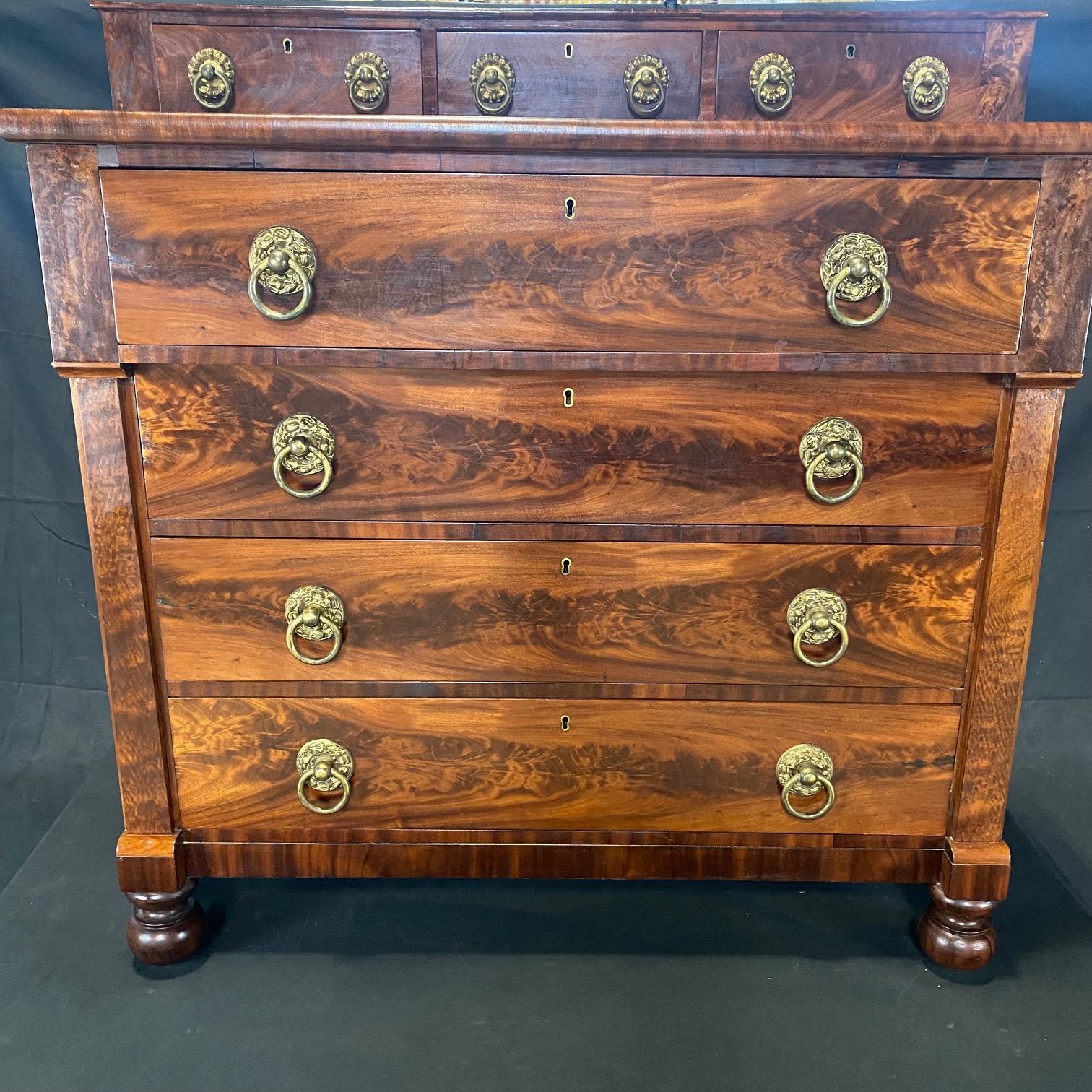 Sheraton step back chest of drawers with three top drawers over four large drawers, Maine origin, circa mid 1800s. With a step back profile and overhanging top drawer, bearing elements of both the Sheraton and Empire styles, the commode features