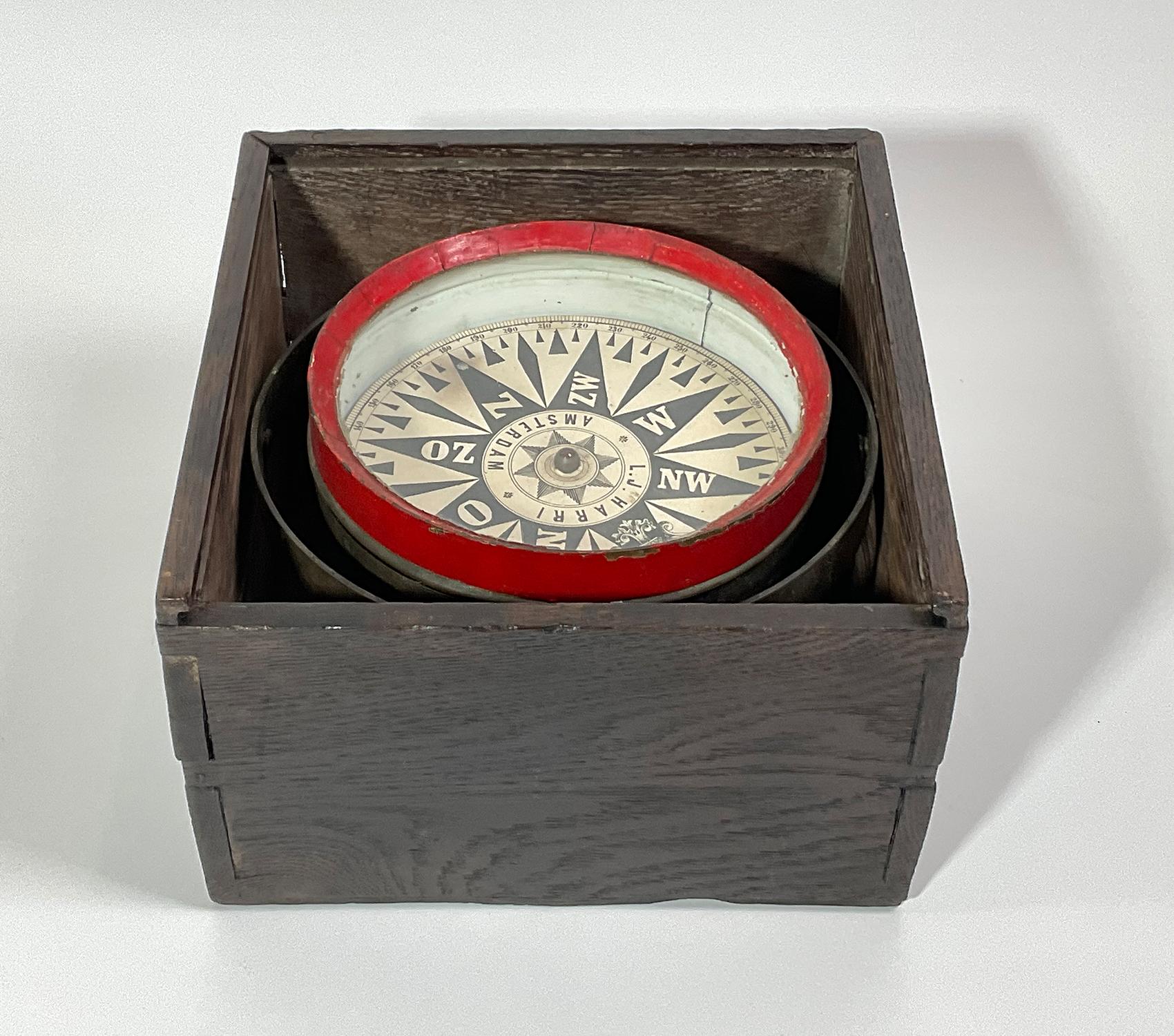 Antique ships compass with interesting Dutch lettering. Spun brass bowl with gimbal. Fitted to a primitive dovetailed box. Circa 1880. With compass card from L.J. Harri, Amsterdam.