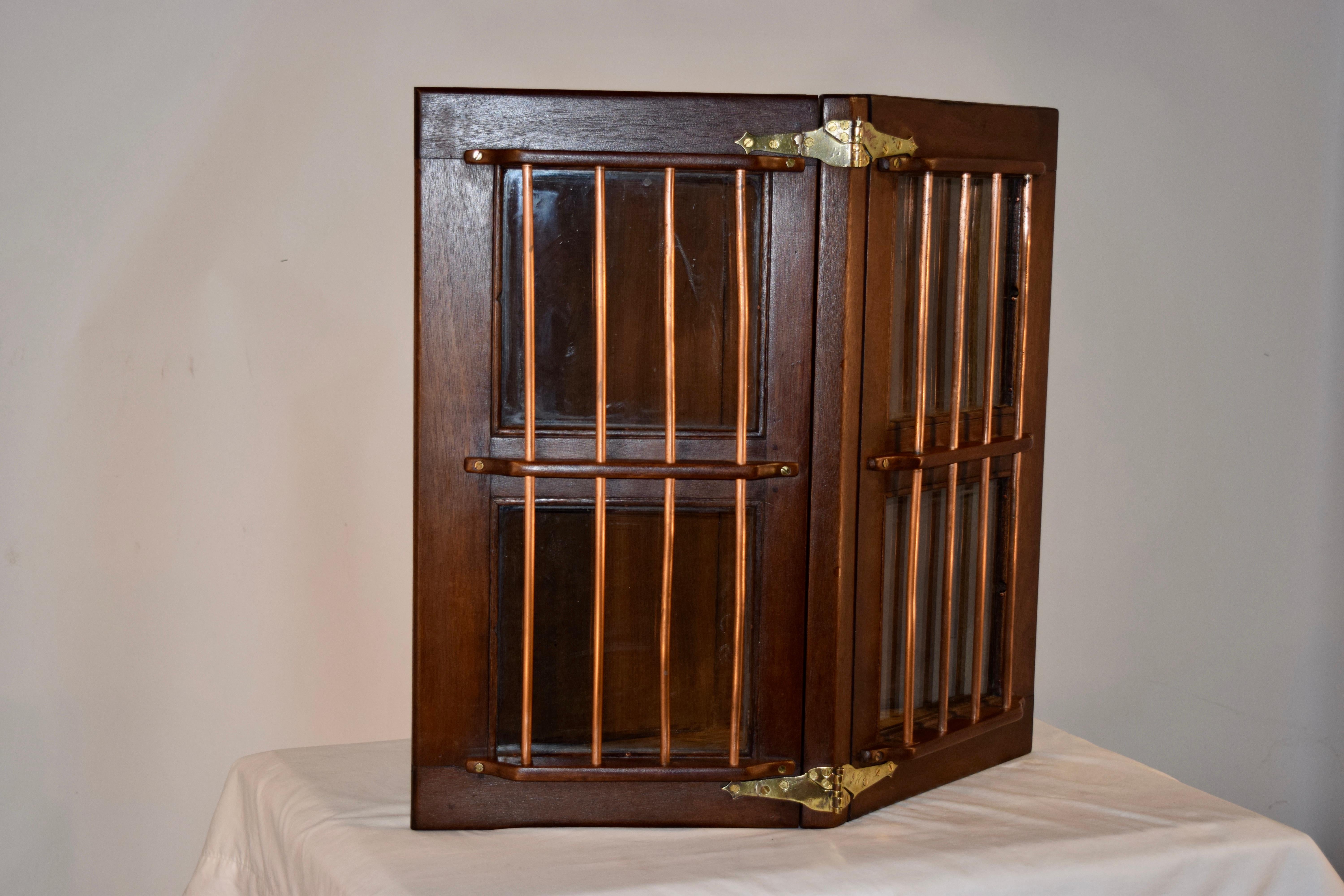 19th Century ship's hatch doors from England made from teak wood and copper rods, which have been added to a custom cabinet back for a unique addition to any room in your home. The doors open to reveal shelving.