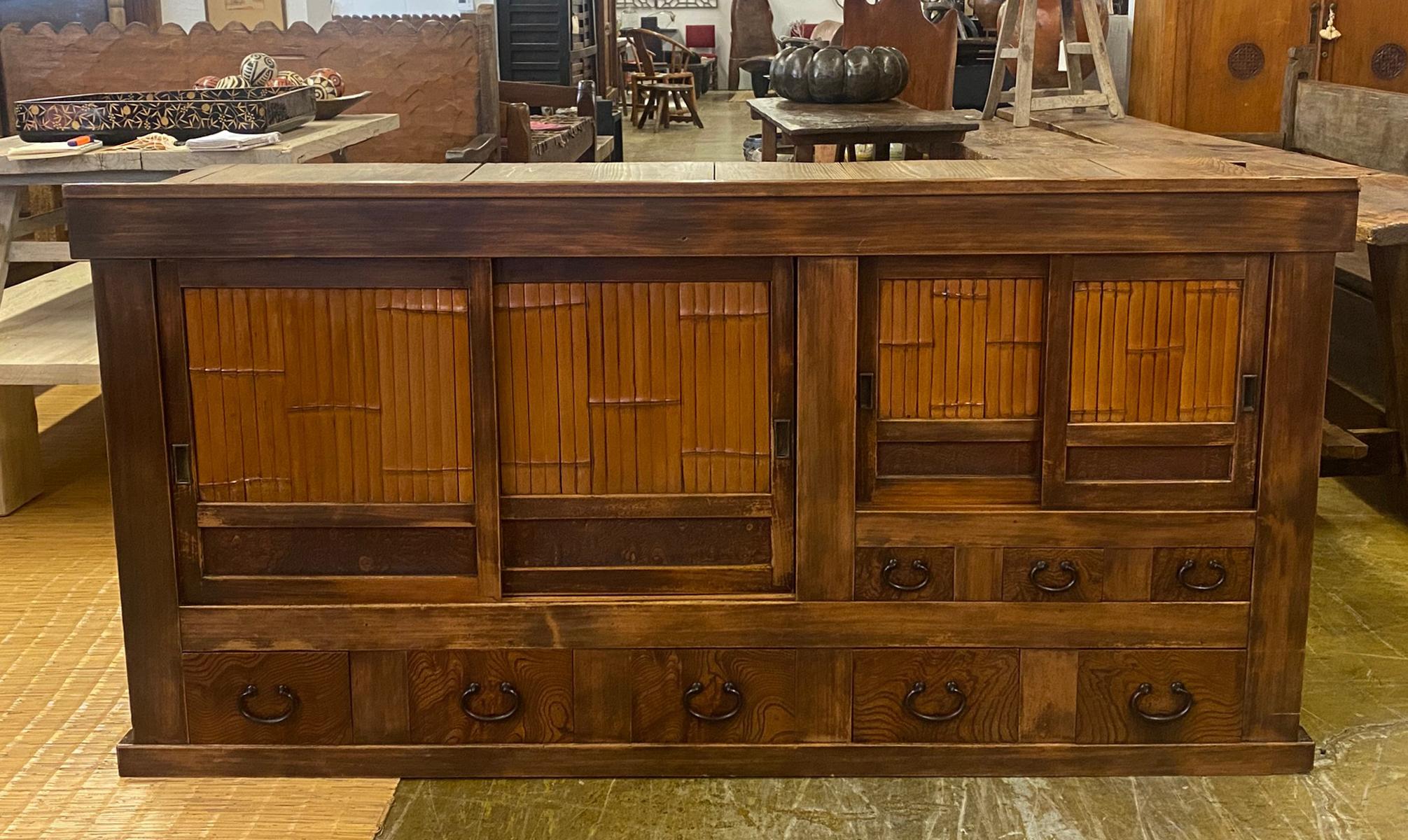 This is an upper part of a an unusual 19th century Japanese cabinet using bamboo and burled wood as design accents on the two sliding door sections and the drawers. The color of the wood variations of  rich honey .   This is a well constructed