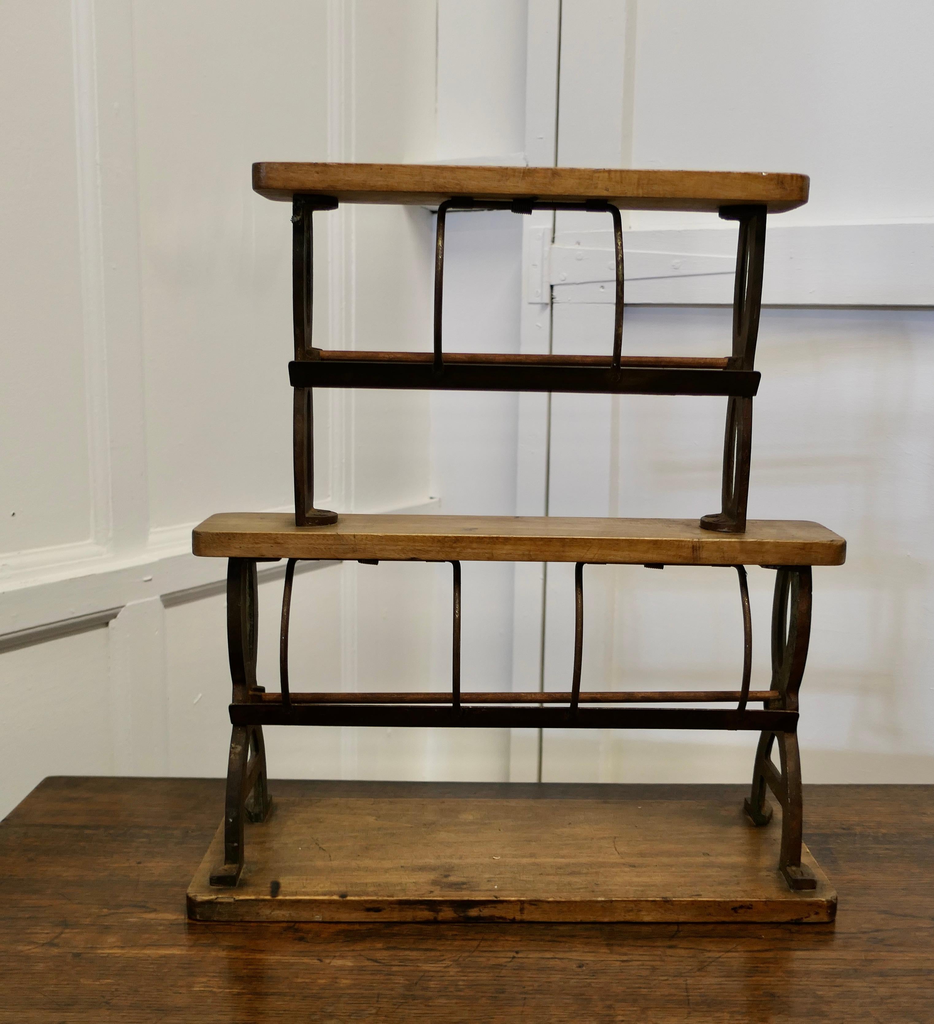 19th century shop double paper roll cutter dispenser

This is a rare and very unusual paper roll cutter, the stand is made in Beech and Iron, it holds 2 rolls of paper, the roll holders are set behind a heavy serrated cutting edge, so that when