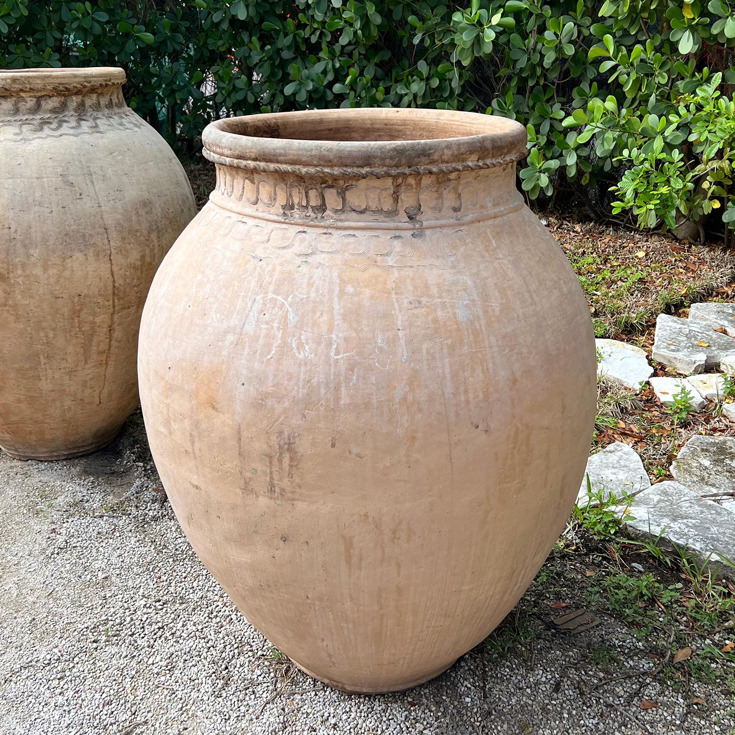A terracotta clay Sicilian Oil Jar or amphora, in good condition. The mouth of this 19th Century garden vessel is decorated with fine décor. These typical Sicilian jars were traditionally used to store olive oil. These pots have no handles and have