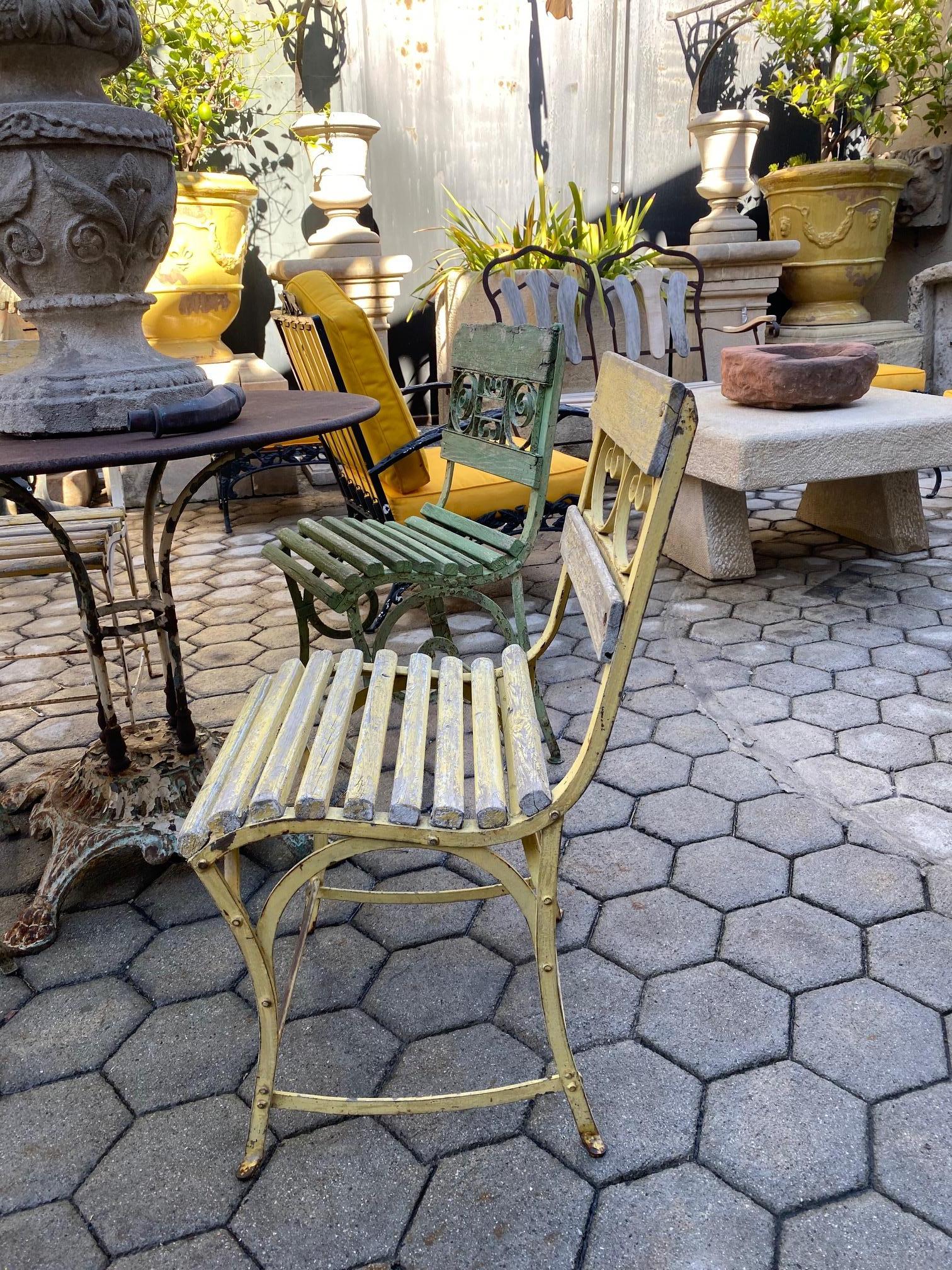 Beautiful 19th century side garden patio iron metal and carved wood chairs with old paint furniture, from the hippodrome horse racing track located in Paris, France. We have total of 2 in yellow color, we have some in the blue and gray color.