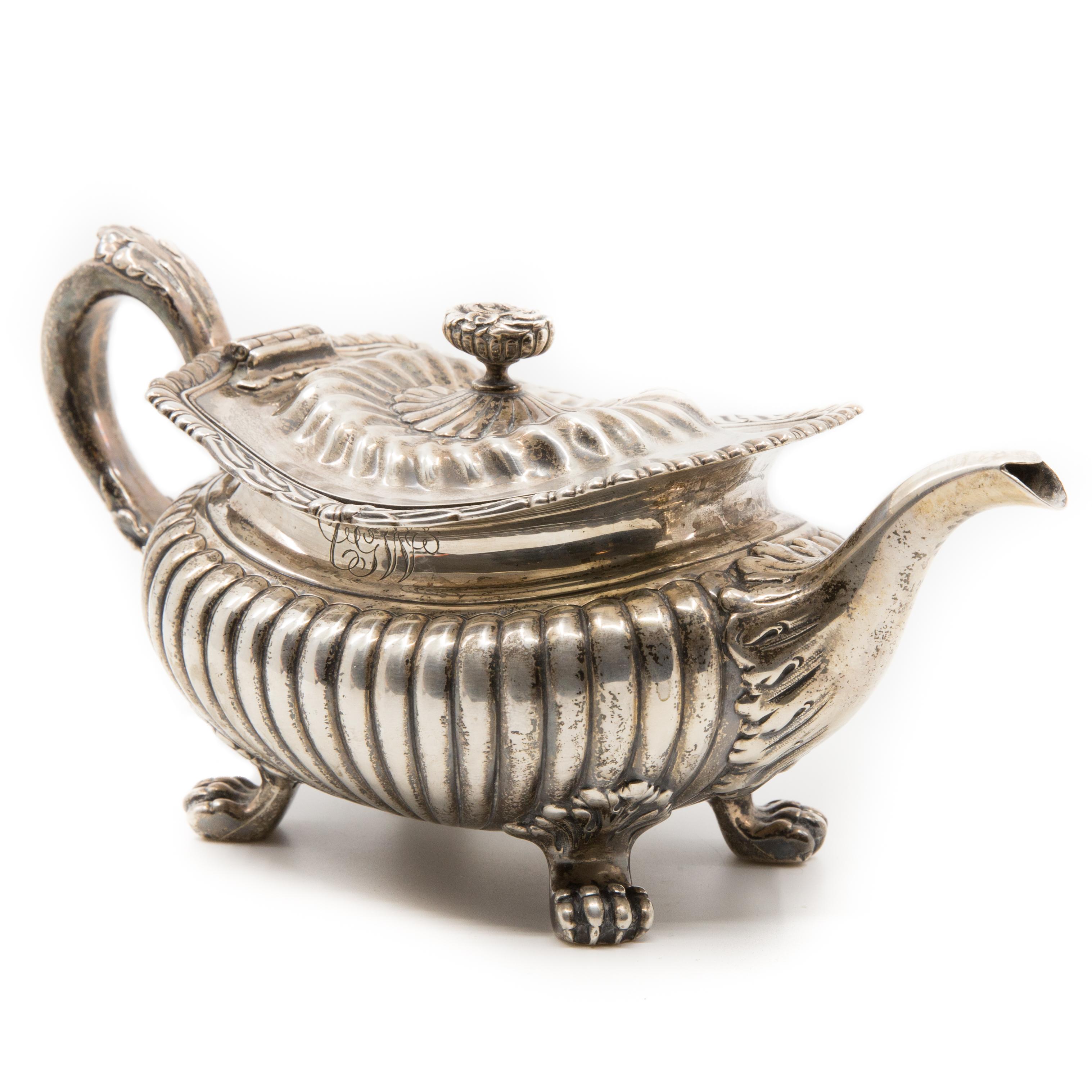 Offered is a vintage 19th century signed and numbered footed sterling silver Georgian style American teapot. The bottom reads as follows: Sterling/ 515/ 1 Pint/ 925/1000 Fine. The side bears the initials CGW and measures approximately 4.5” H x 9.5”