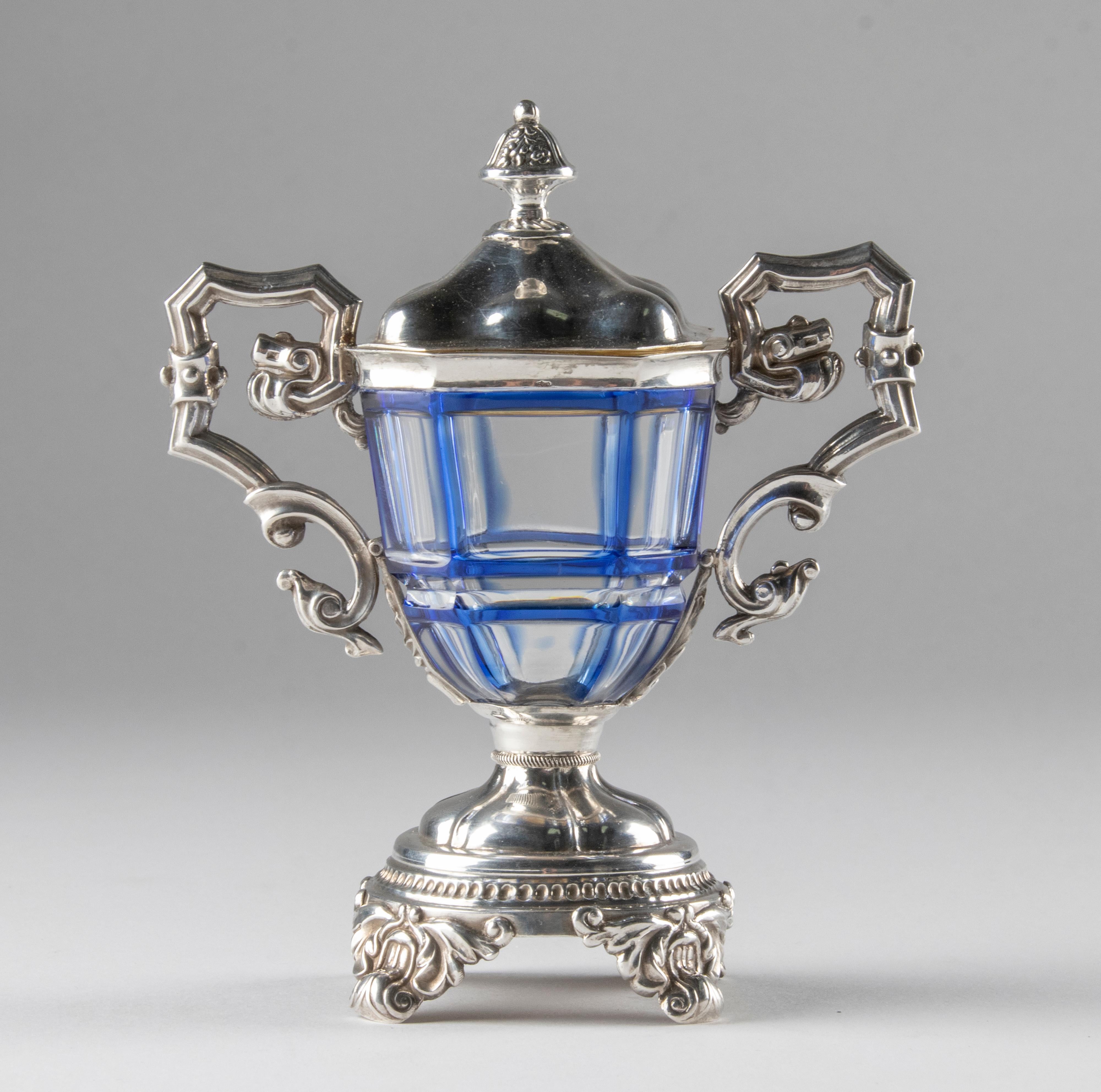 Beautiful late 19th century antique mustard pot. The jar is made of colored (blue) and clear crystal and solid silver. The inside of the lid is gold plated to prevent erosion. The silver is marked with various hall marks. These are not very legible.