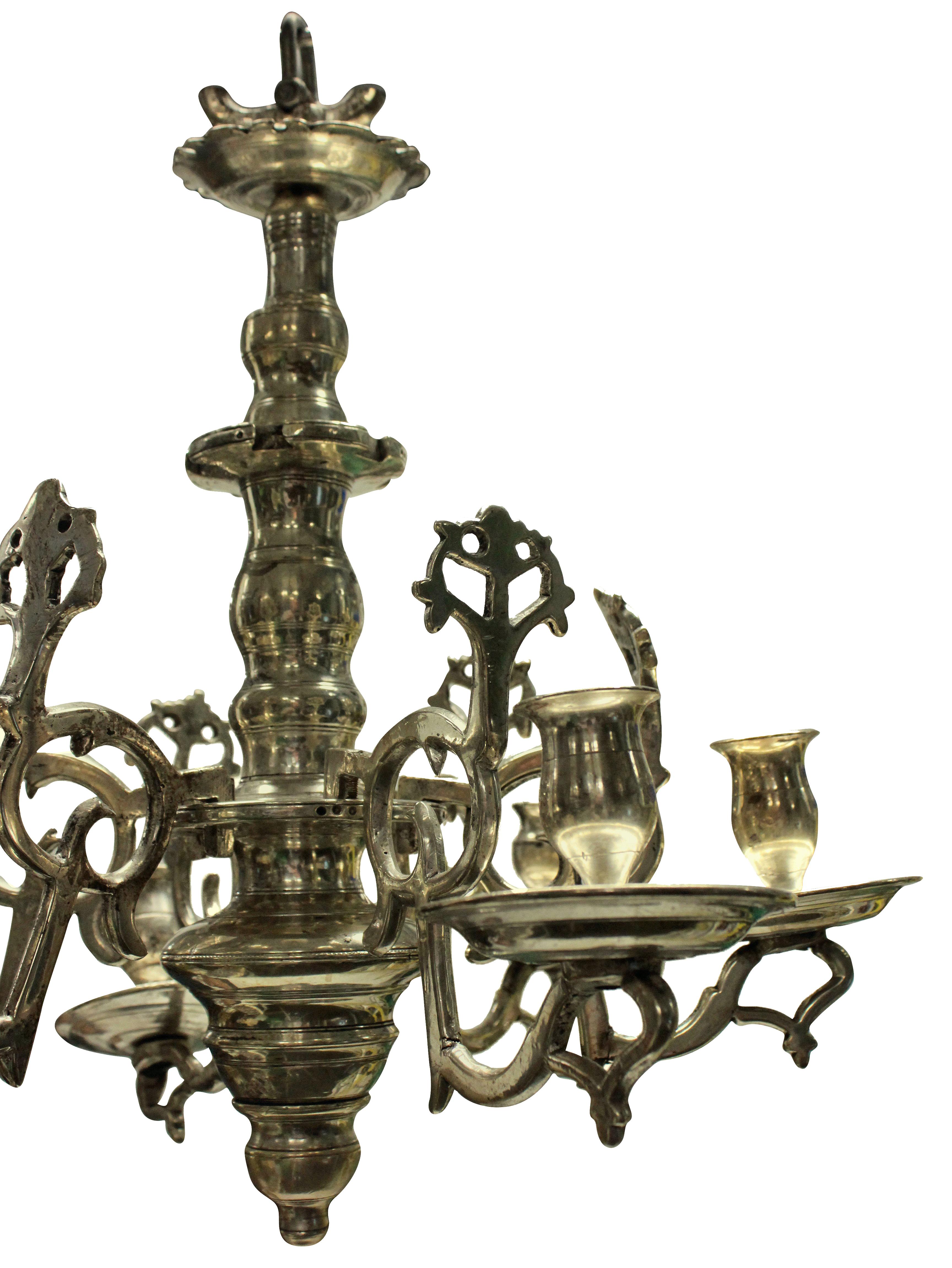 A small Flemish chandelier in silver plated bronze, for candles.

 