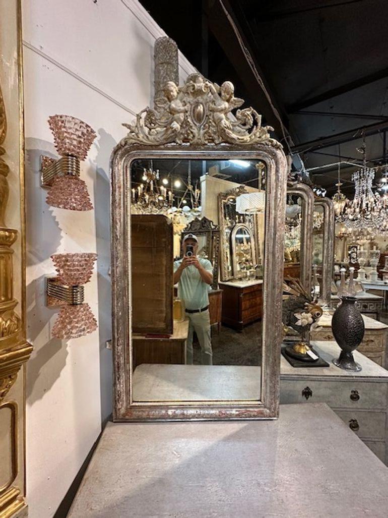 Gorgeous 19th century silver leaf Louis Philippe mirror with gesso cheribum. Makes an elegant statement!!