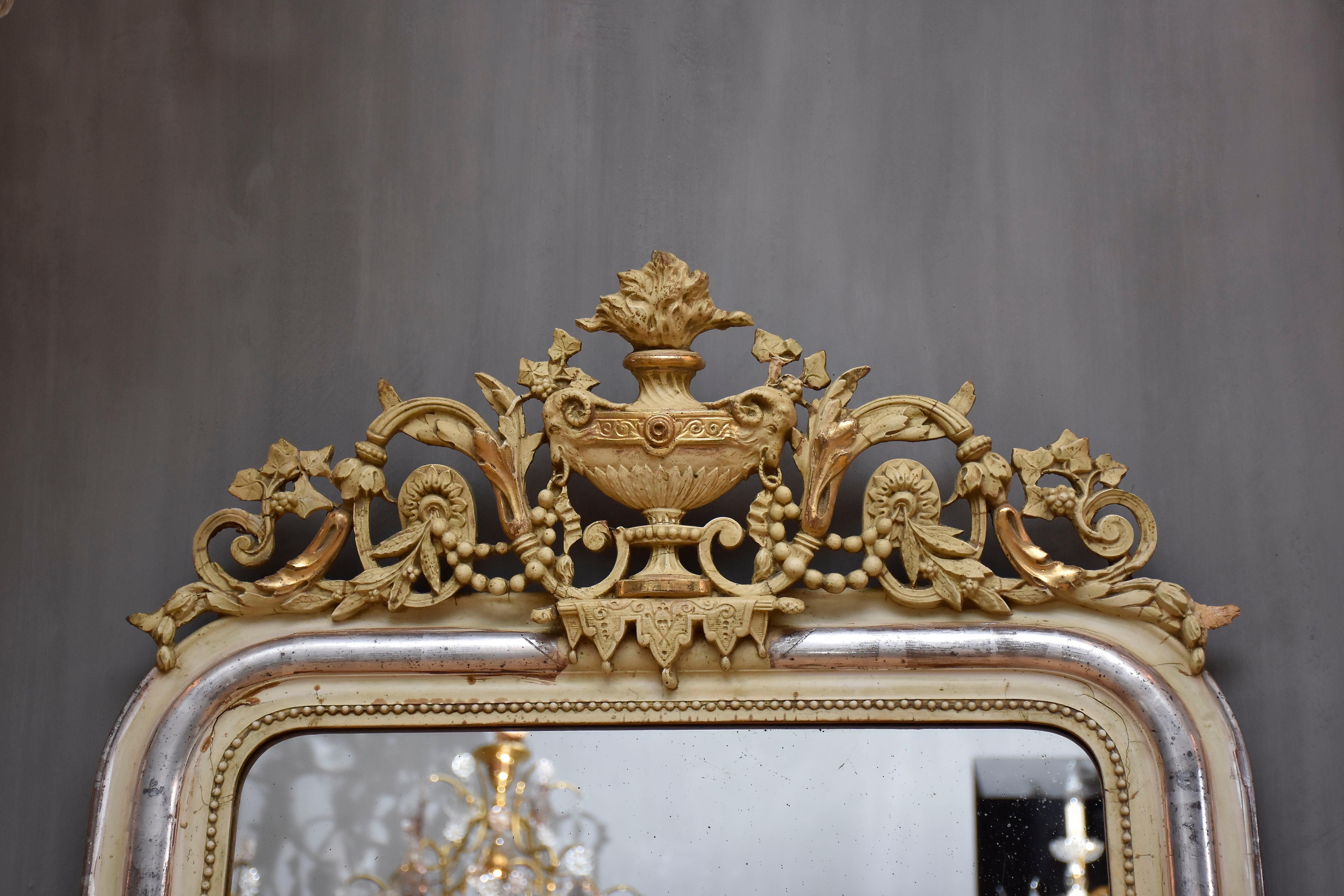 Gilt 19th century silver leaf gilt French mirror with a crest For Sale