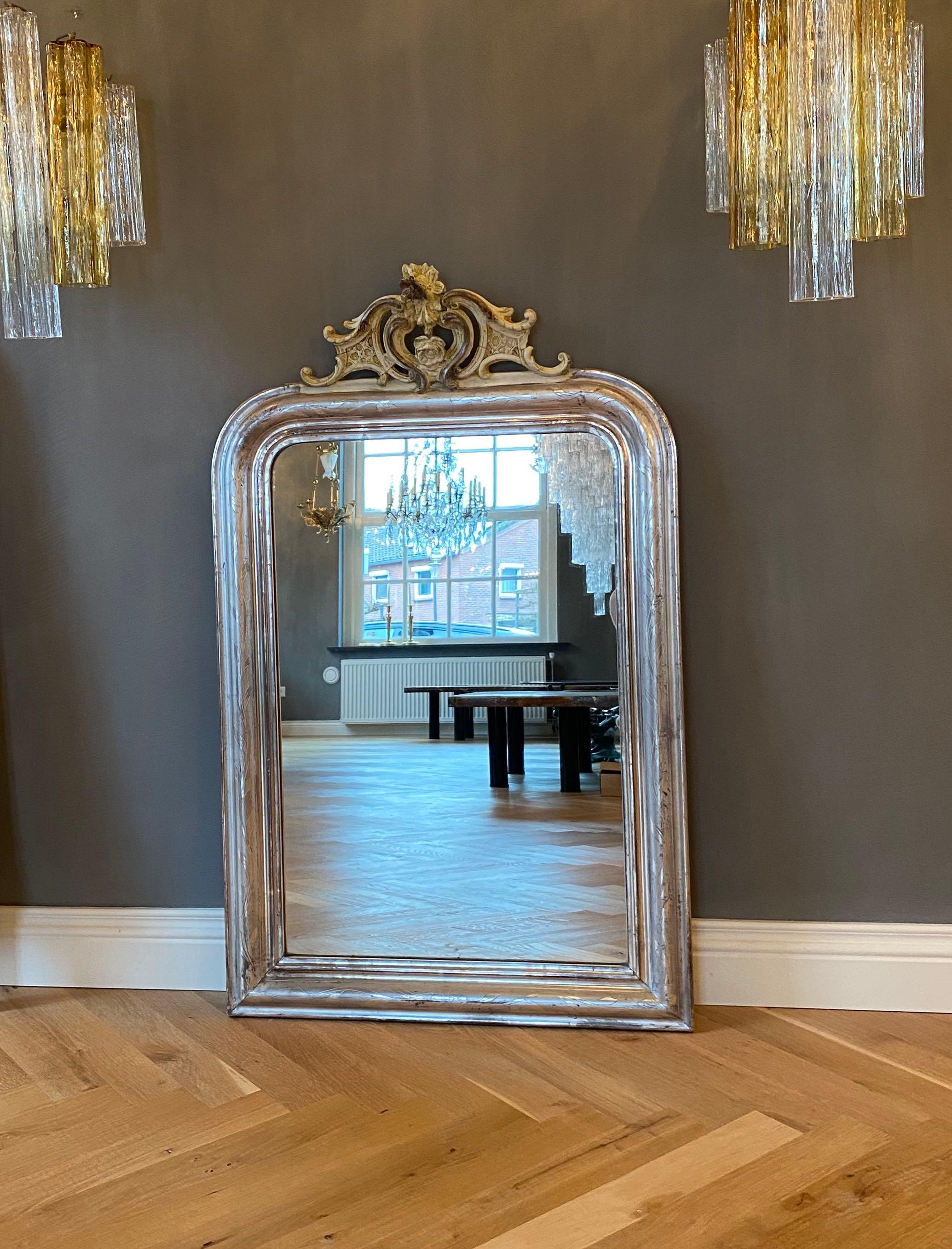 Glass 19th century silver leaf gilt French mirror with a crest For Sale