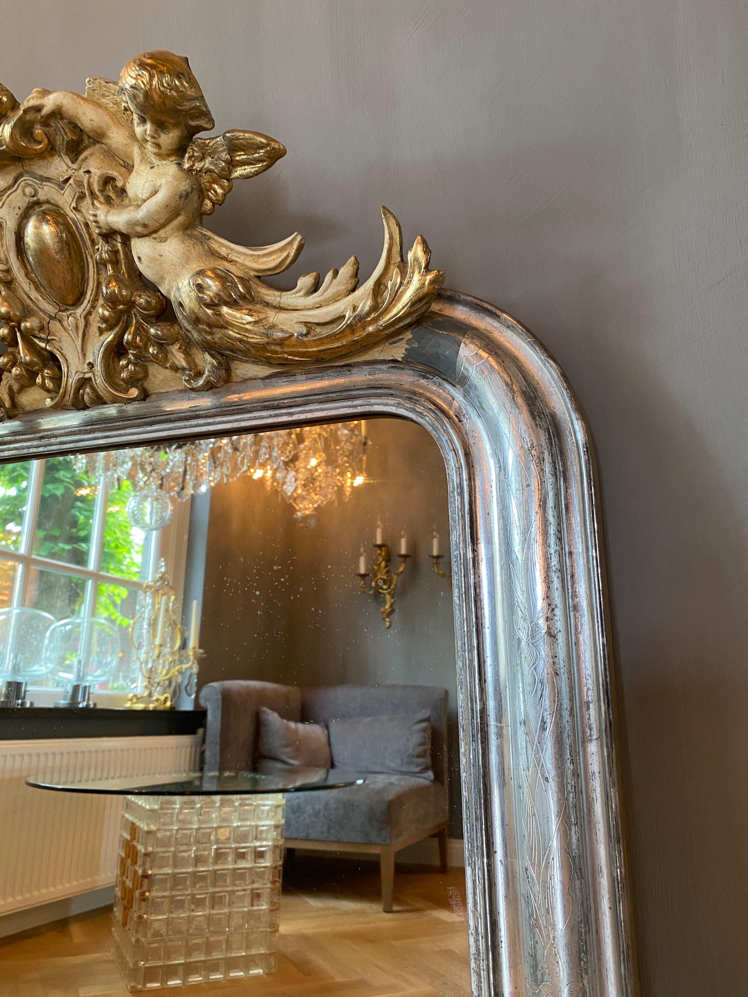 Louis Philippe 19th century silver leaf gilt French mirror with a crest with putti