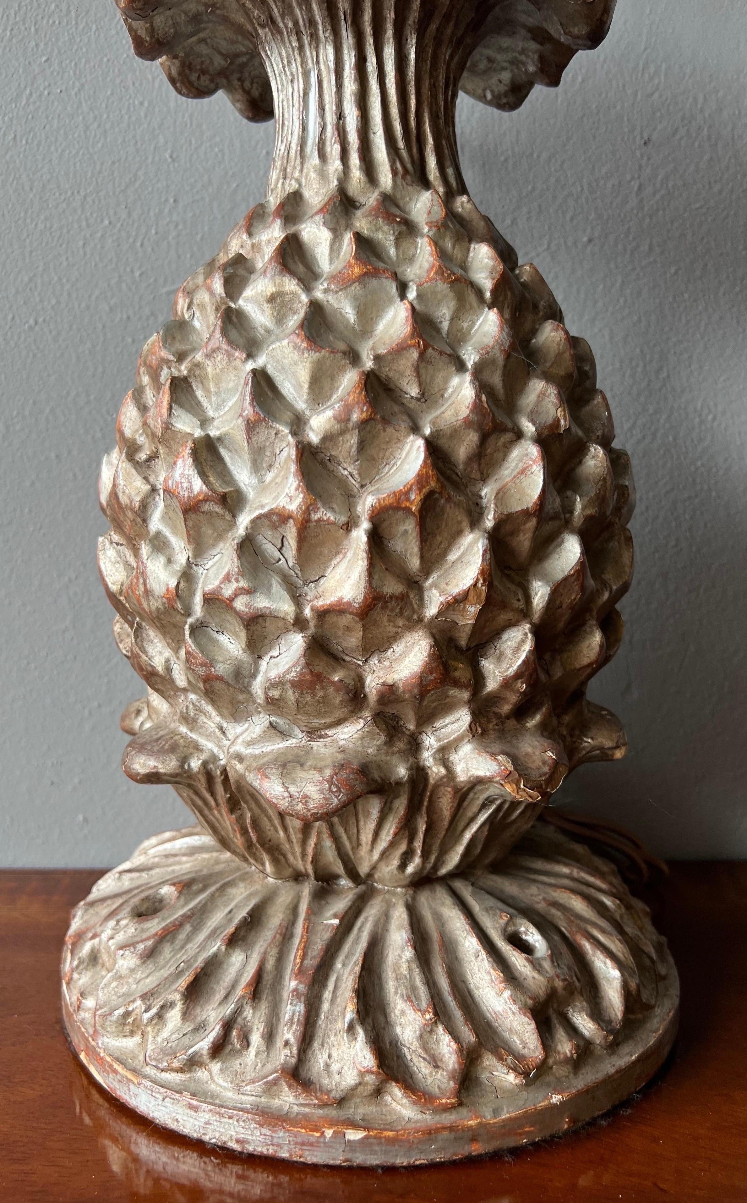 Carved wood and silver leaf stylized pineapple form lamp.